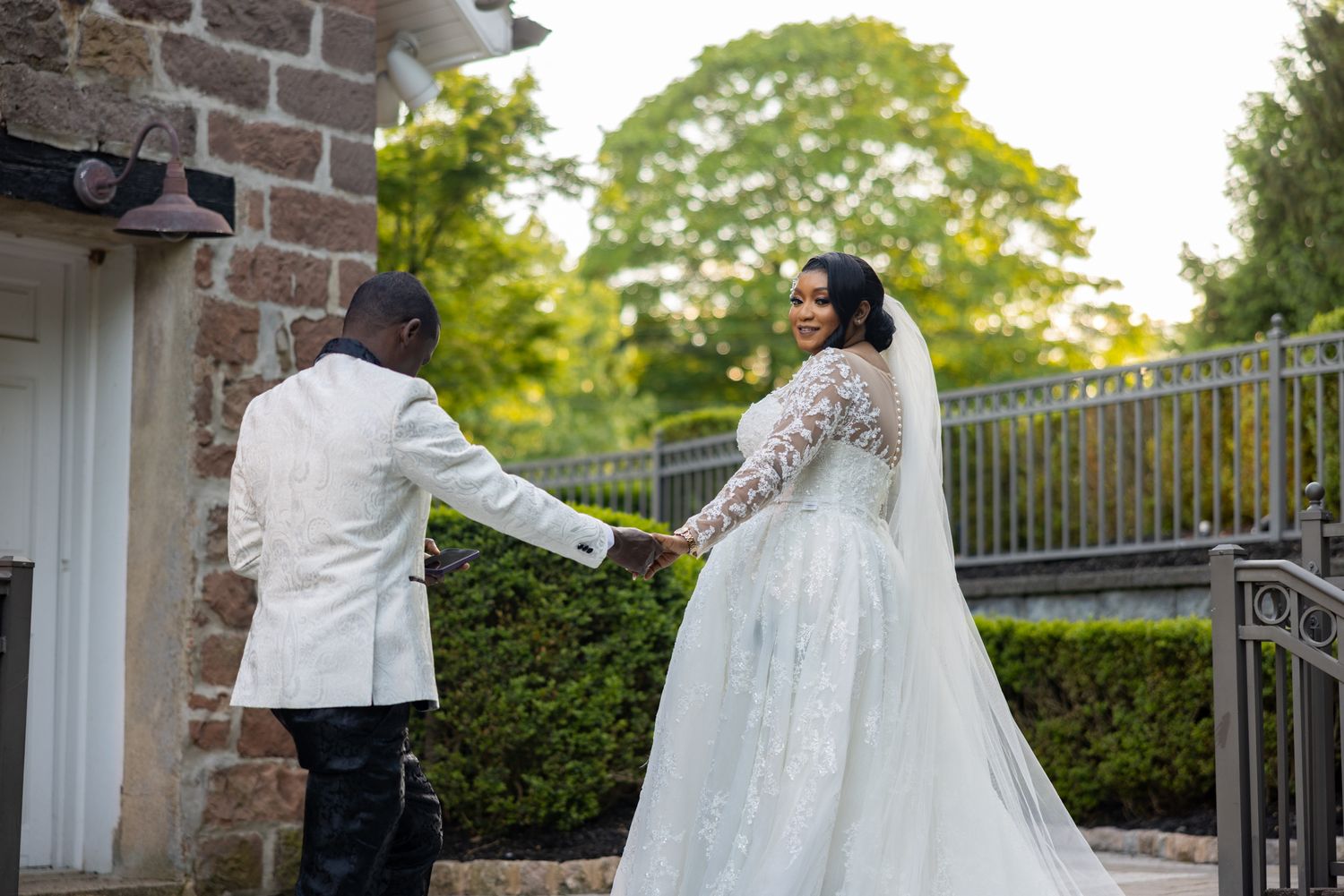 A wedding photoshoot sequence captured outdoors with a rustic brick wall and greenery background.
