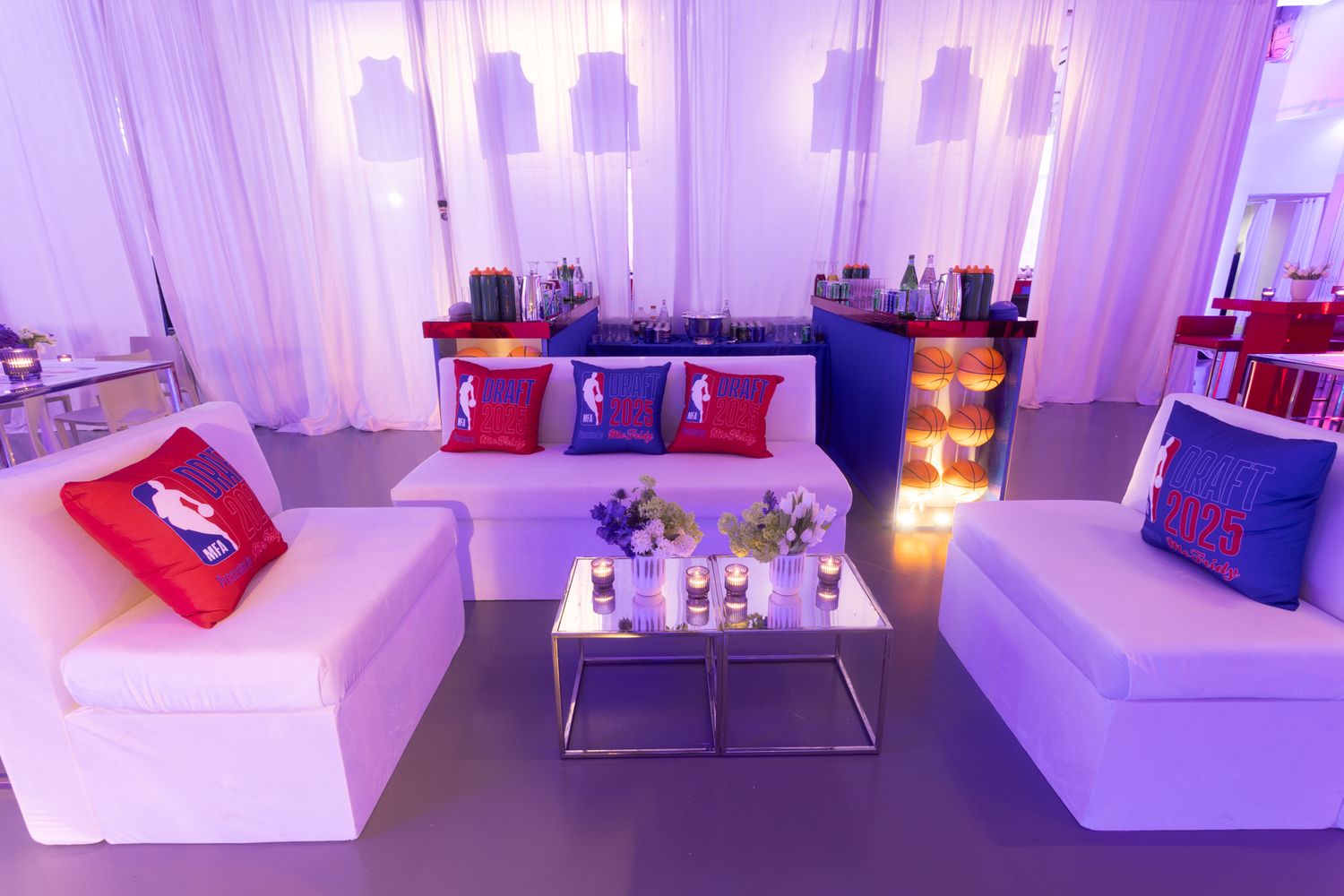 Modern lounge area with purple lighting features white modular seating and contemporary decor.