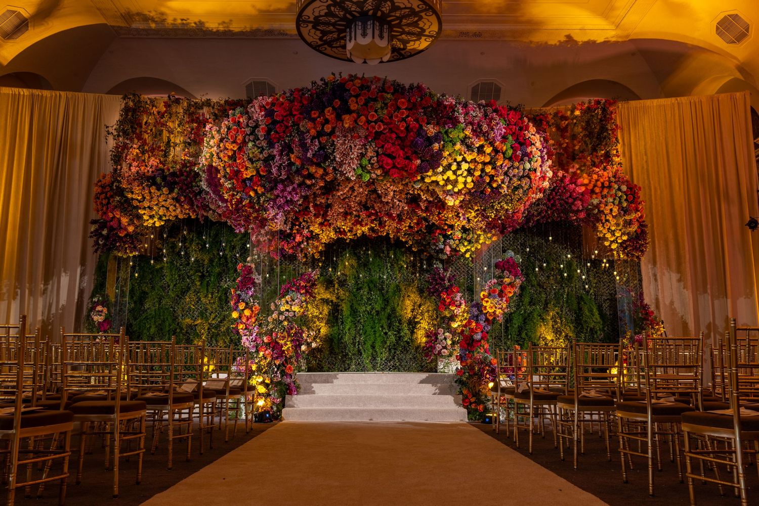 Romantic wedding venue decorated with lush floral arrangements and warm lighting creating a magical atmosphere.