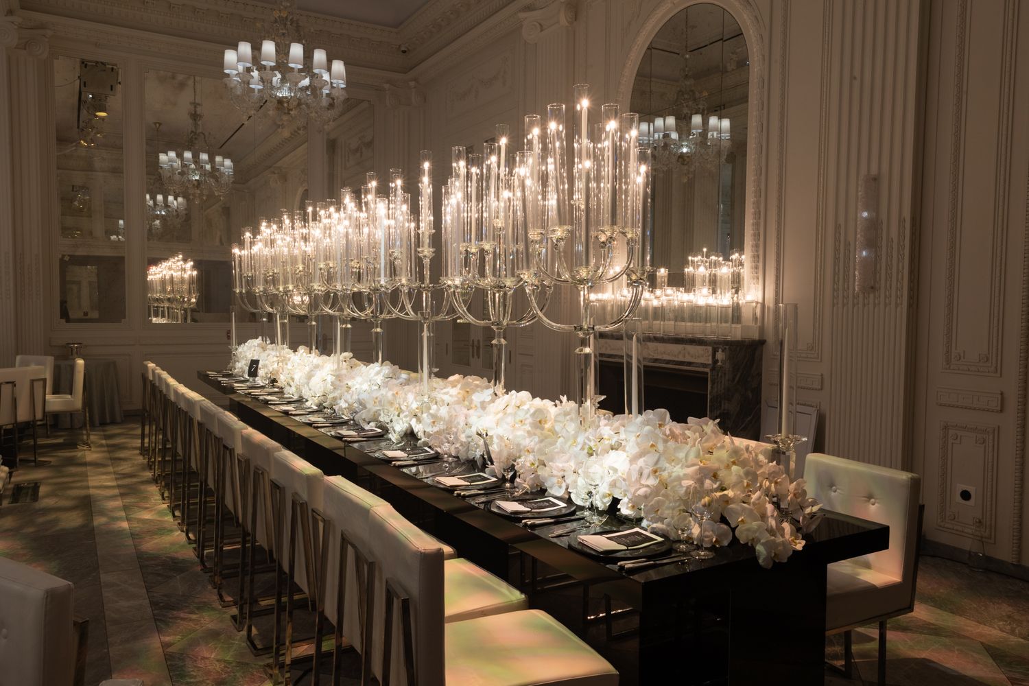 Elegant ballroom with crystal chandeliers and long tables set for a formal dinner reception.