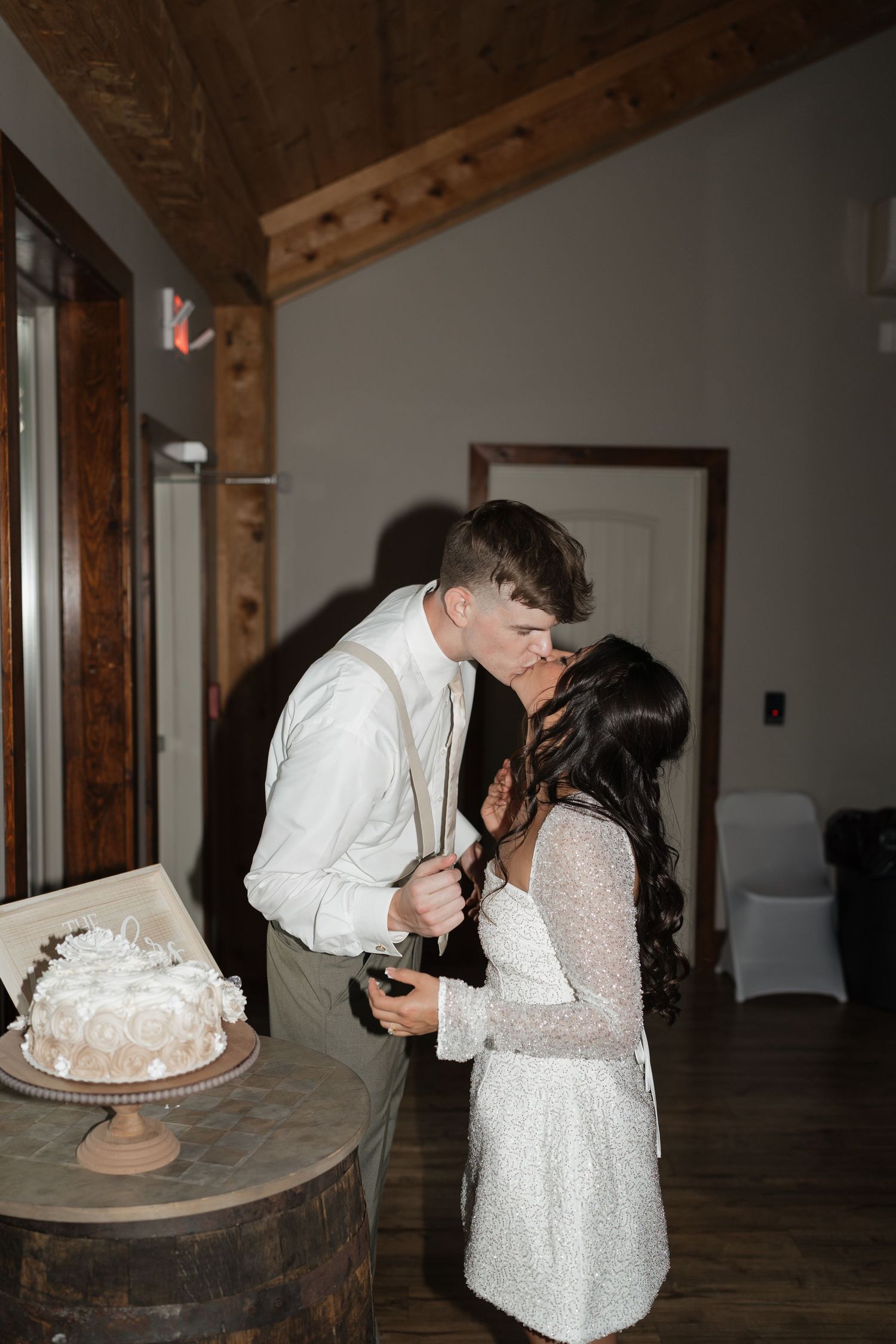 Wedding photographer in Delphi, Indiana capturing bride and groom cake cutting during reception at Stone Creek Lodge in Crawfordsville, IN