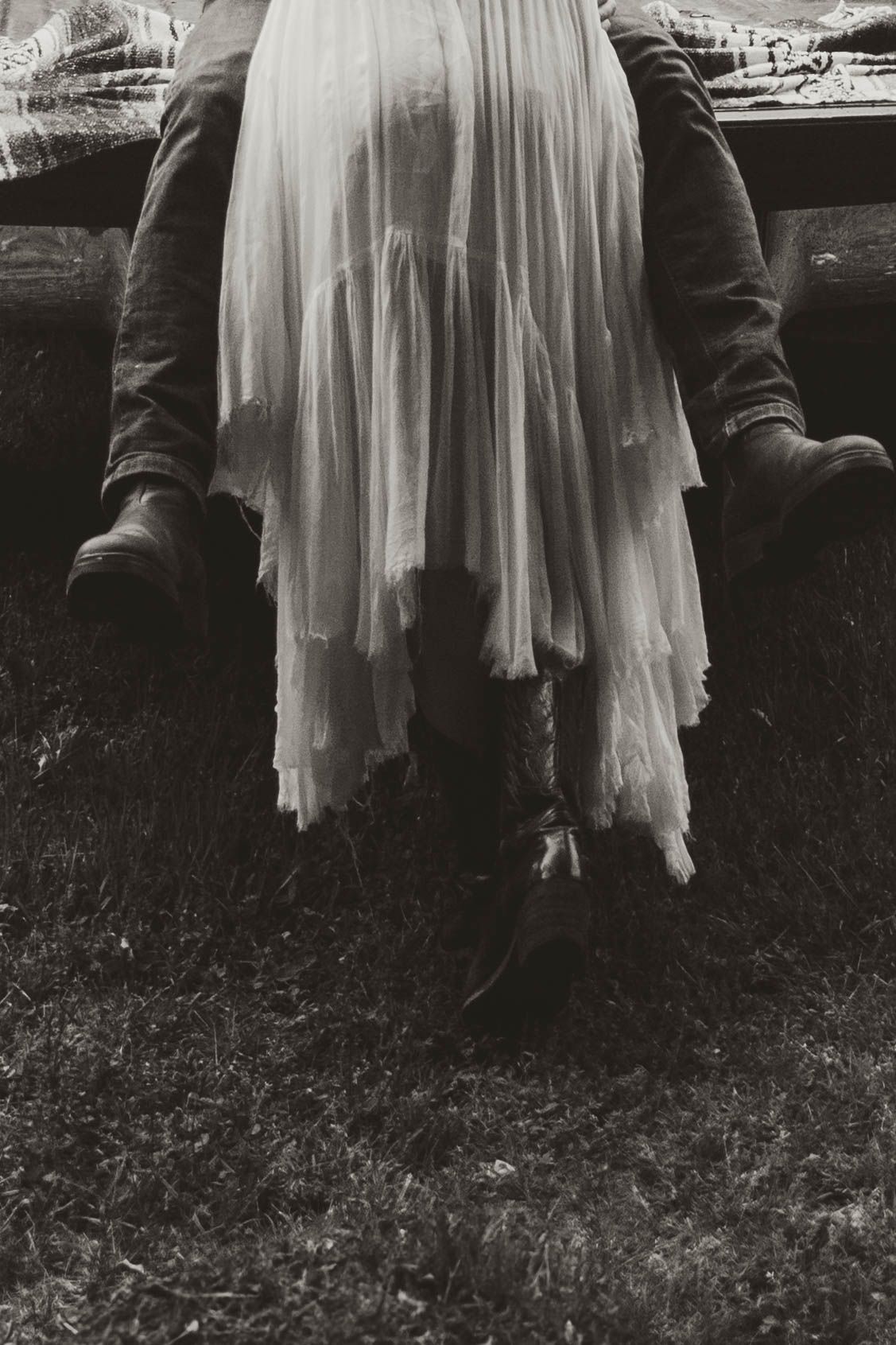 Artistic black and white photos showing the hem of a flowing white dress against grass.