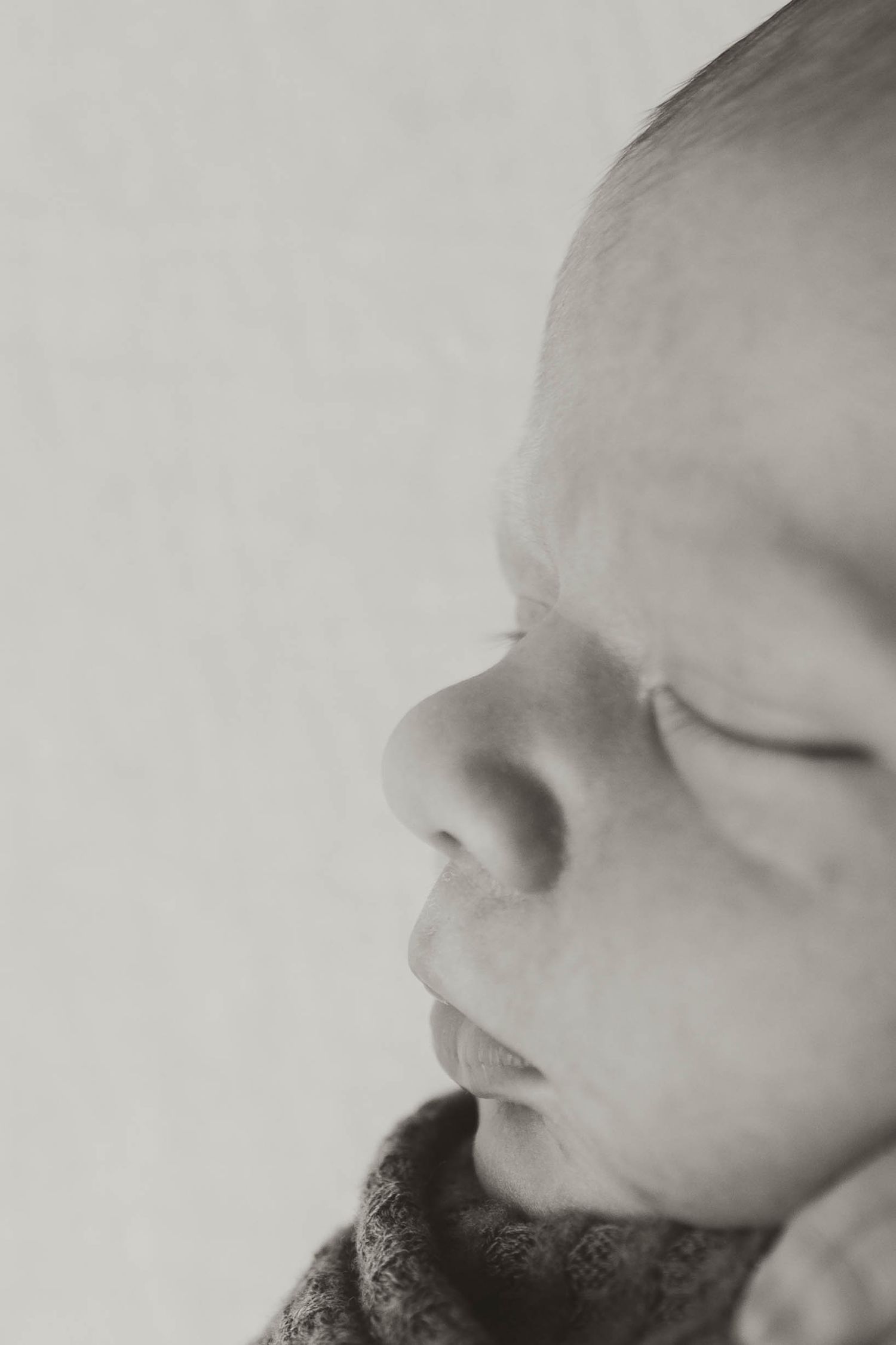 Artistic black and white macro shot of facial features in profile.