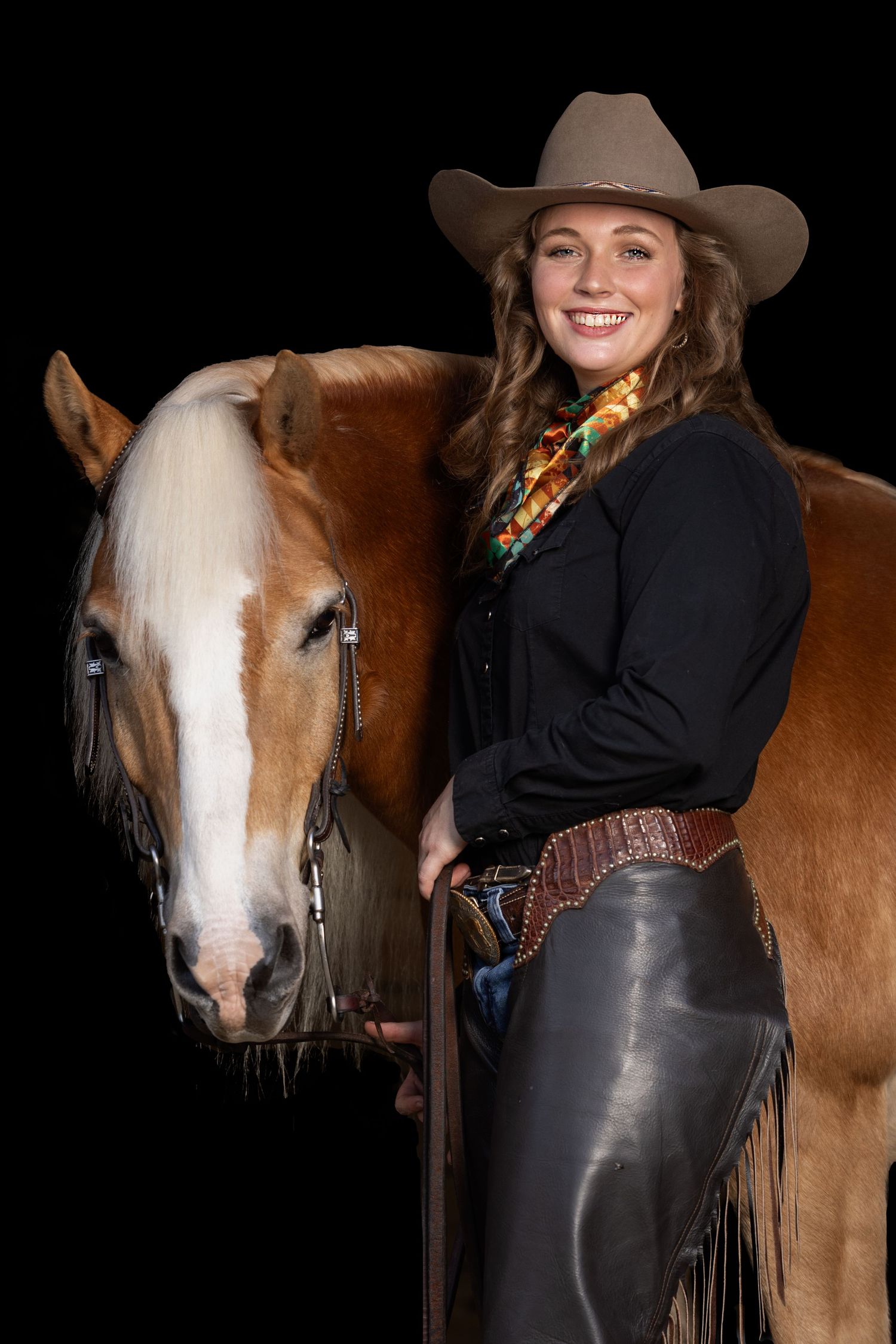 artistic black background portraits showing western equestrian style with horse by Keli Wakeley Photography portrait session.