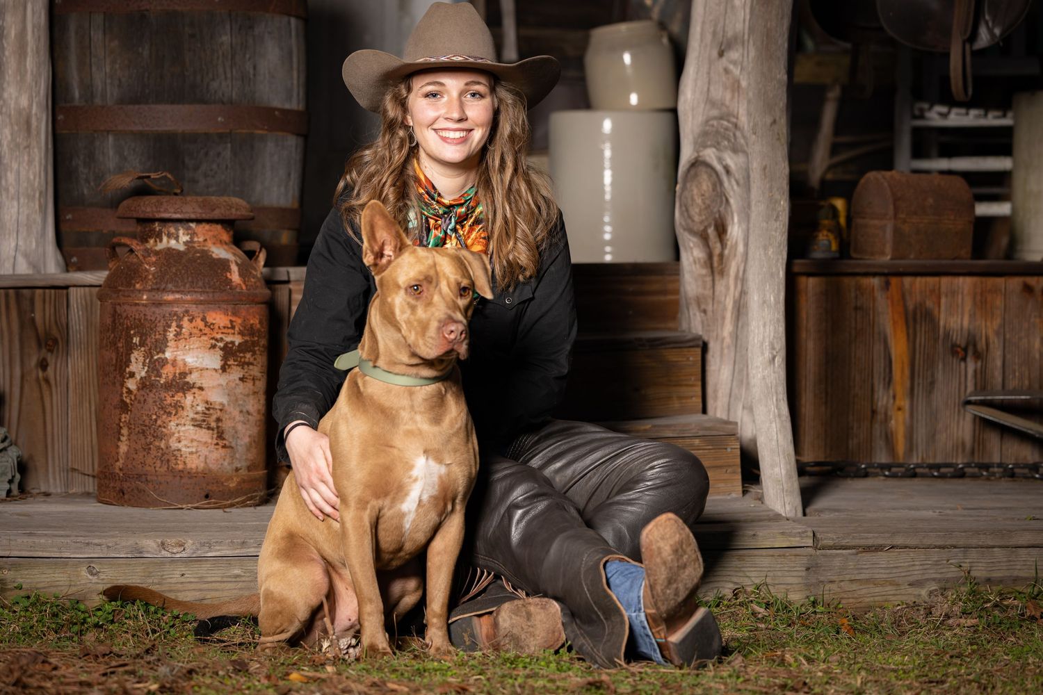 Rustic barn setting photoshoot with dog and owner in a western town setting Ocala Florida. Kei Wakeley Photography portrait Session.