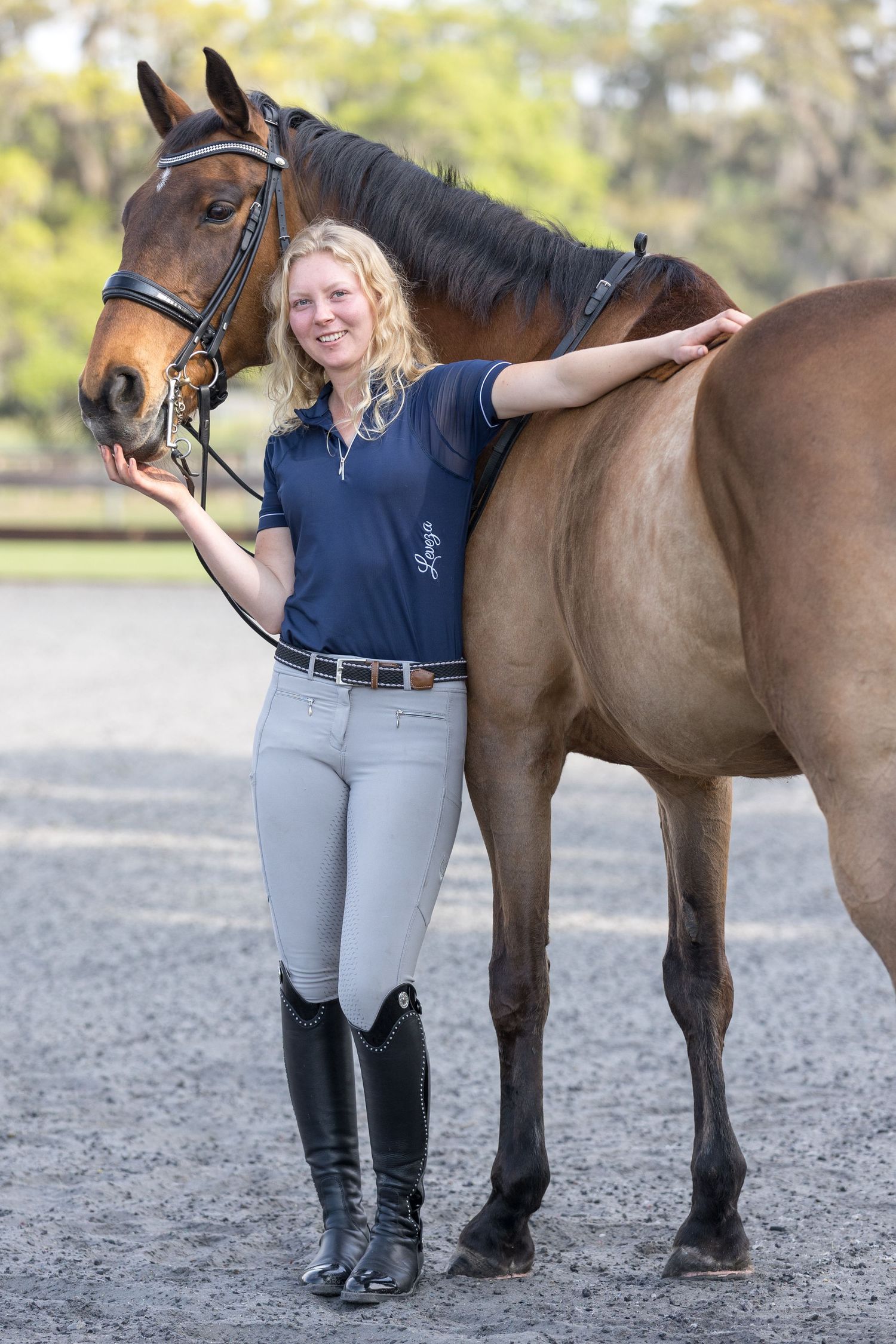 Dressage rider and horse posing for fall branding portrait session Ariel Boesener Performance Horses with Keli Wakeley Photography