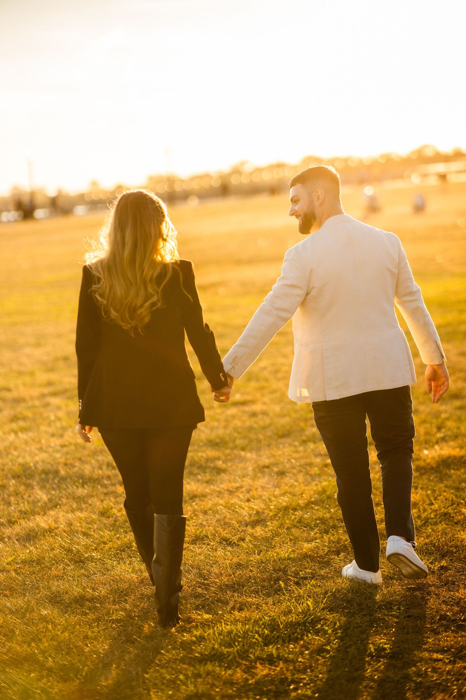 Golden hour couple portrait in tall grass at Liberty State Park – Jersey City engagement session.