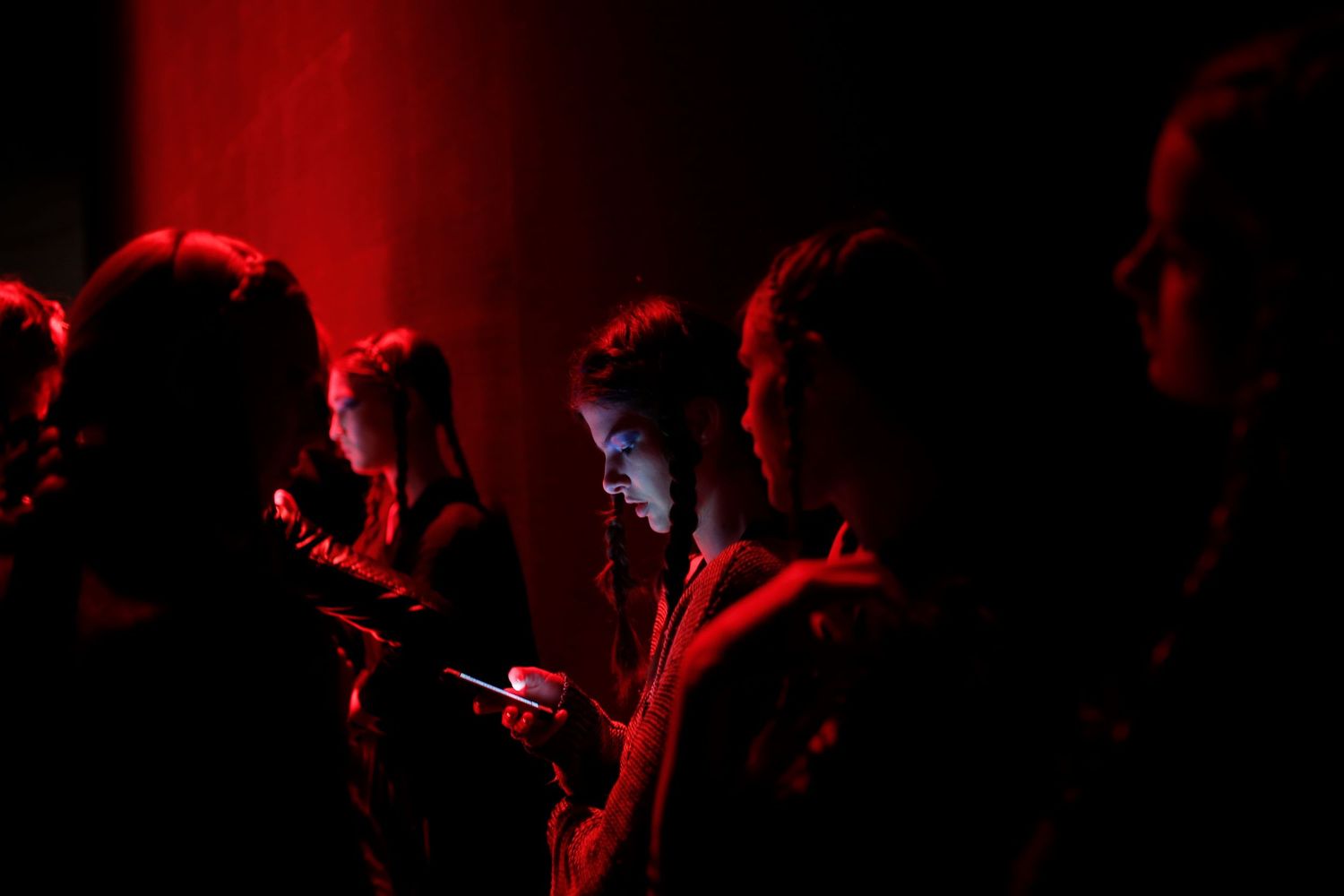 Behind-the-scenes moment from NYC Fashion Week — models and crew preparing backstage before the runway show.