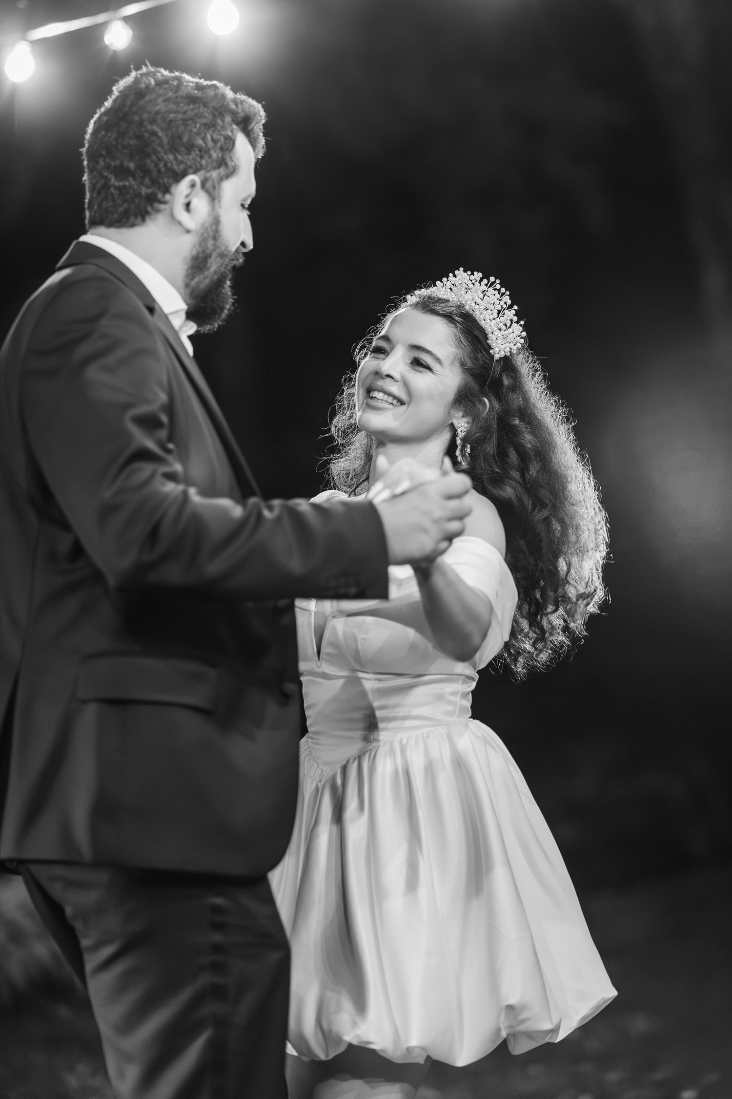 A bride and groom share a romantic dance together in a black and white photograph in NYC.