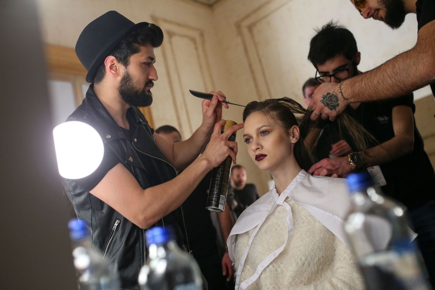 Behind-the-scenes moment from NYC Fashion Week — models and crew preparing backstage before the runway show.