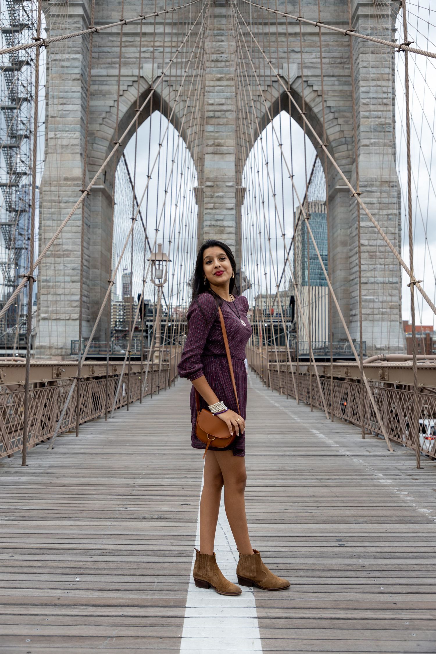 Family photo session on the Brooklyn Bridge in New York City — natural, joyful portraits with an iconic skyline backdrop.