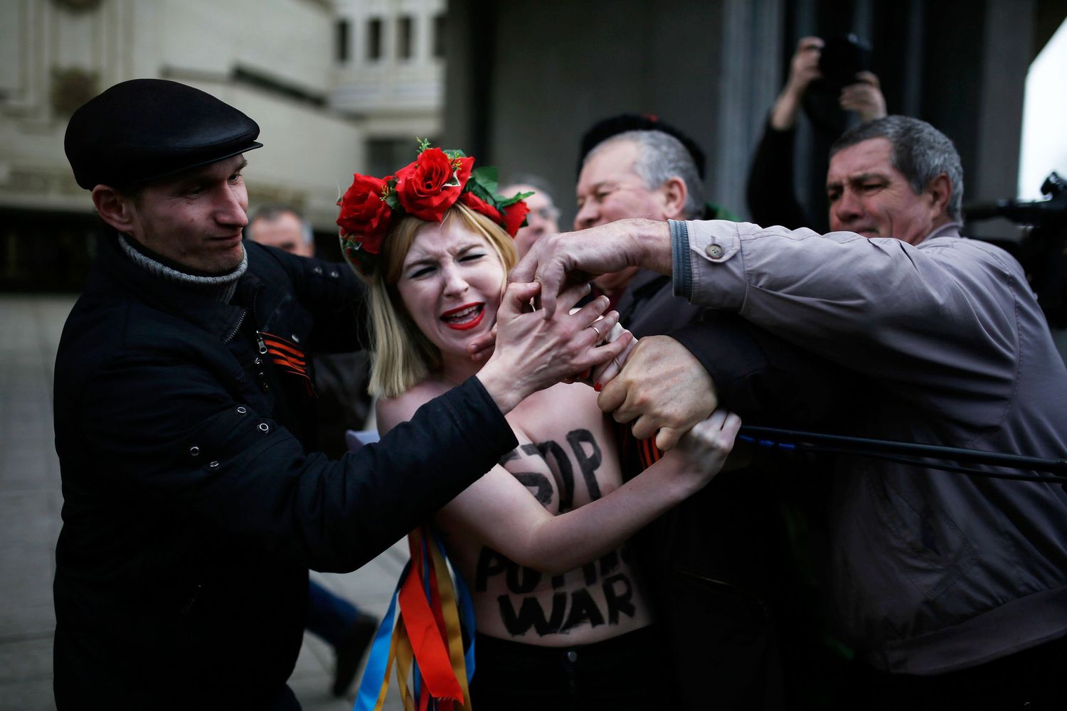 Ukrainian women protesting face confrontation by men during a public demonstration — powerful photojournalism capturing gender dynamics and