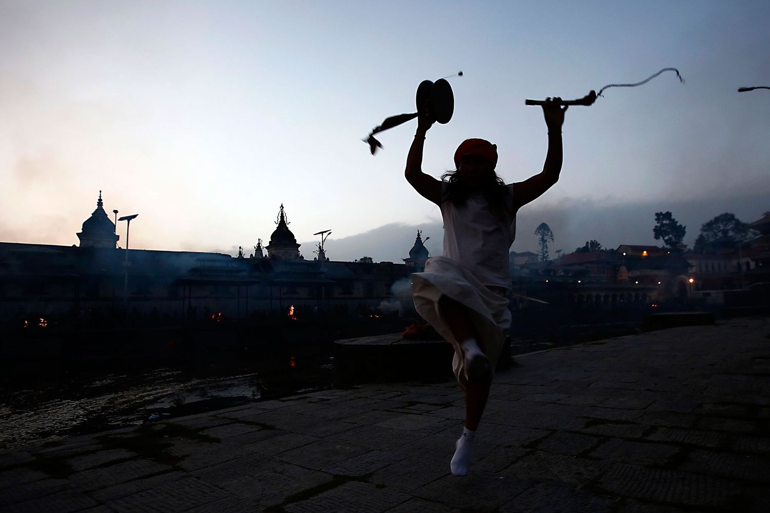A person praying amidst the aftermath of the Nepal earthquake — documentary photojournalism capturing human resilience.