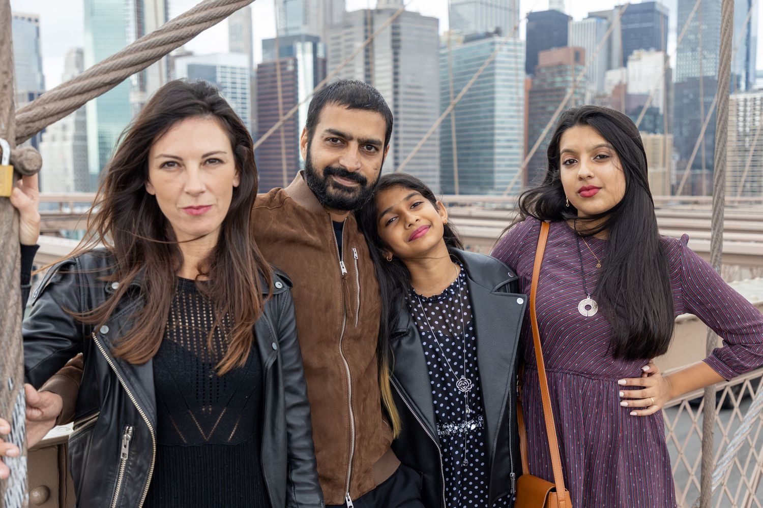 Family photo session on the Brooklyn Bridge in New York City — natural, joyful portraits with an iconic skyline backdrop.