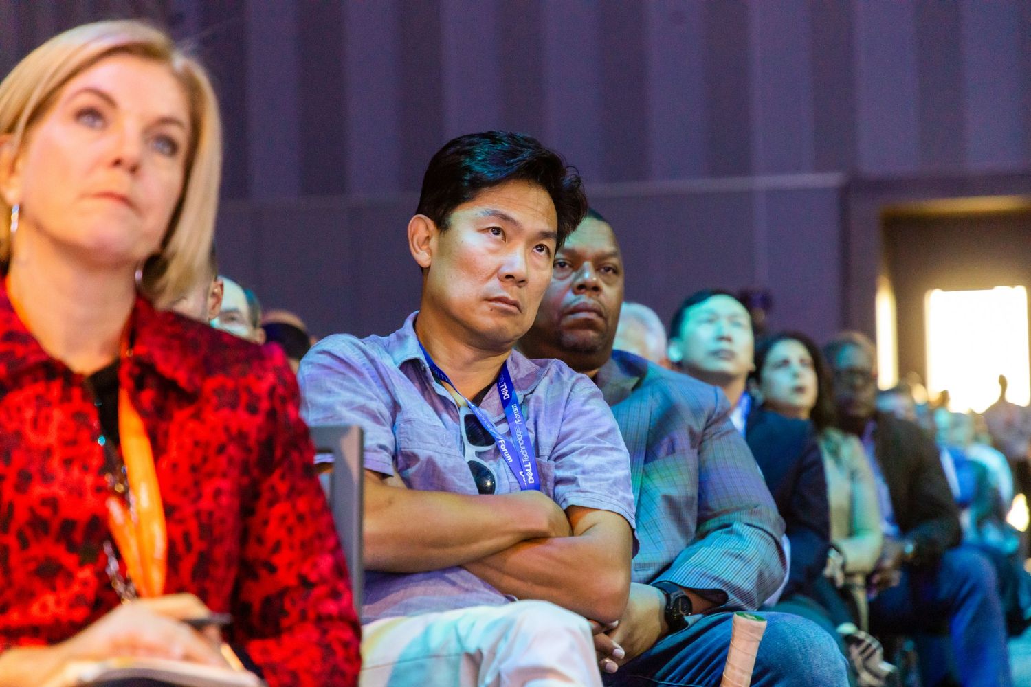 Diverse audience members seated and listening attentively during an indoor event in NYC.