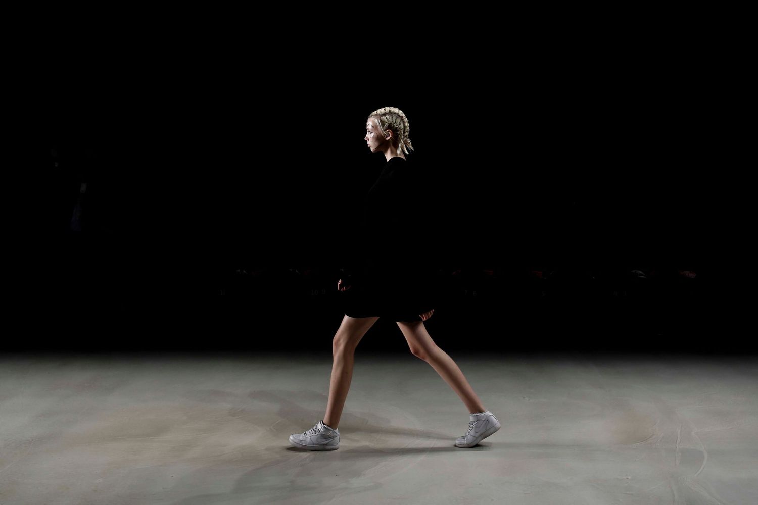 Fashion model walking the runway during NYC Fashion Week — captured mid-stride with confidence and style.
