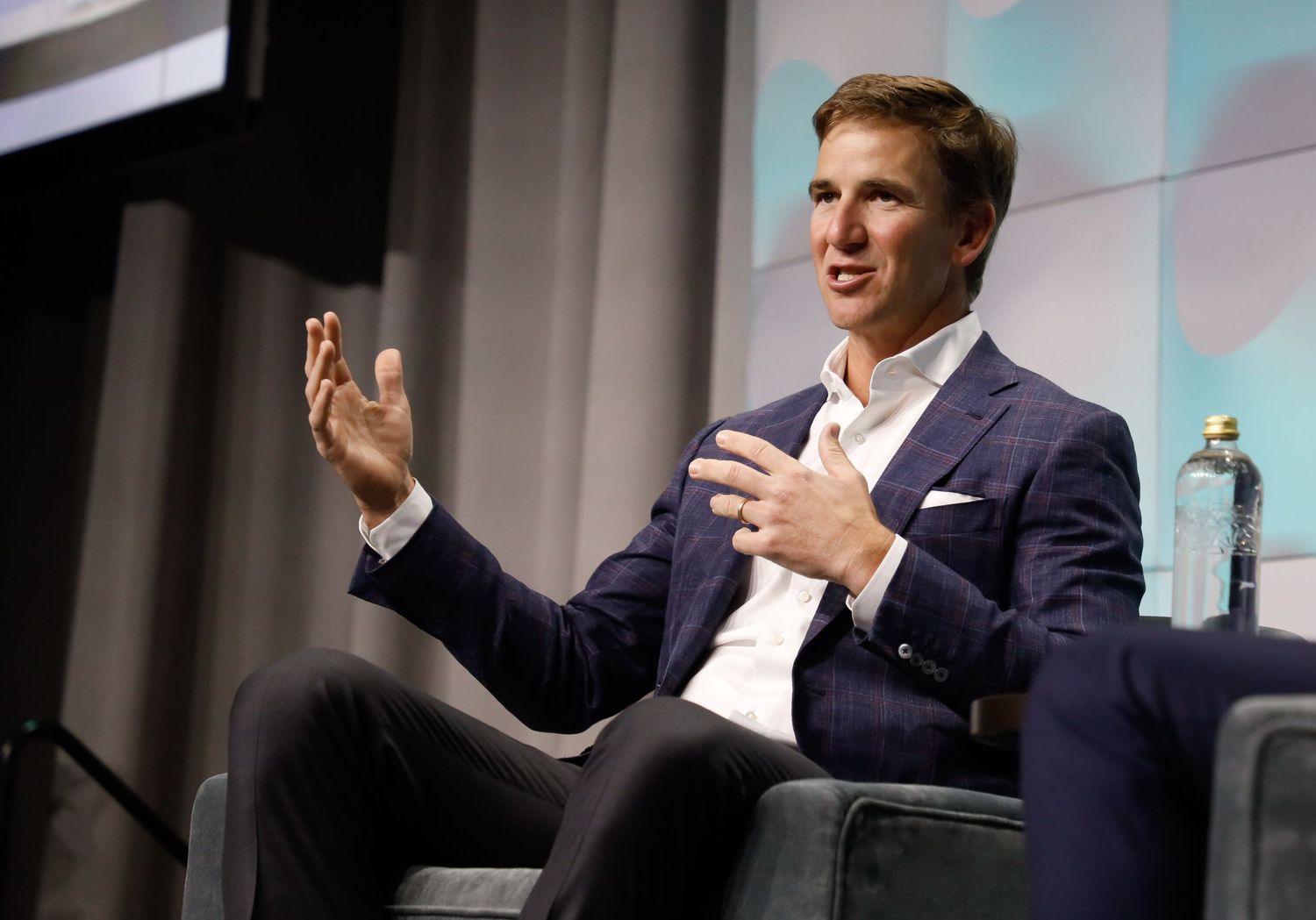 Man in business attire speaking during a formal interview or leadership talk – NYC.