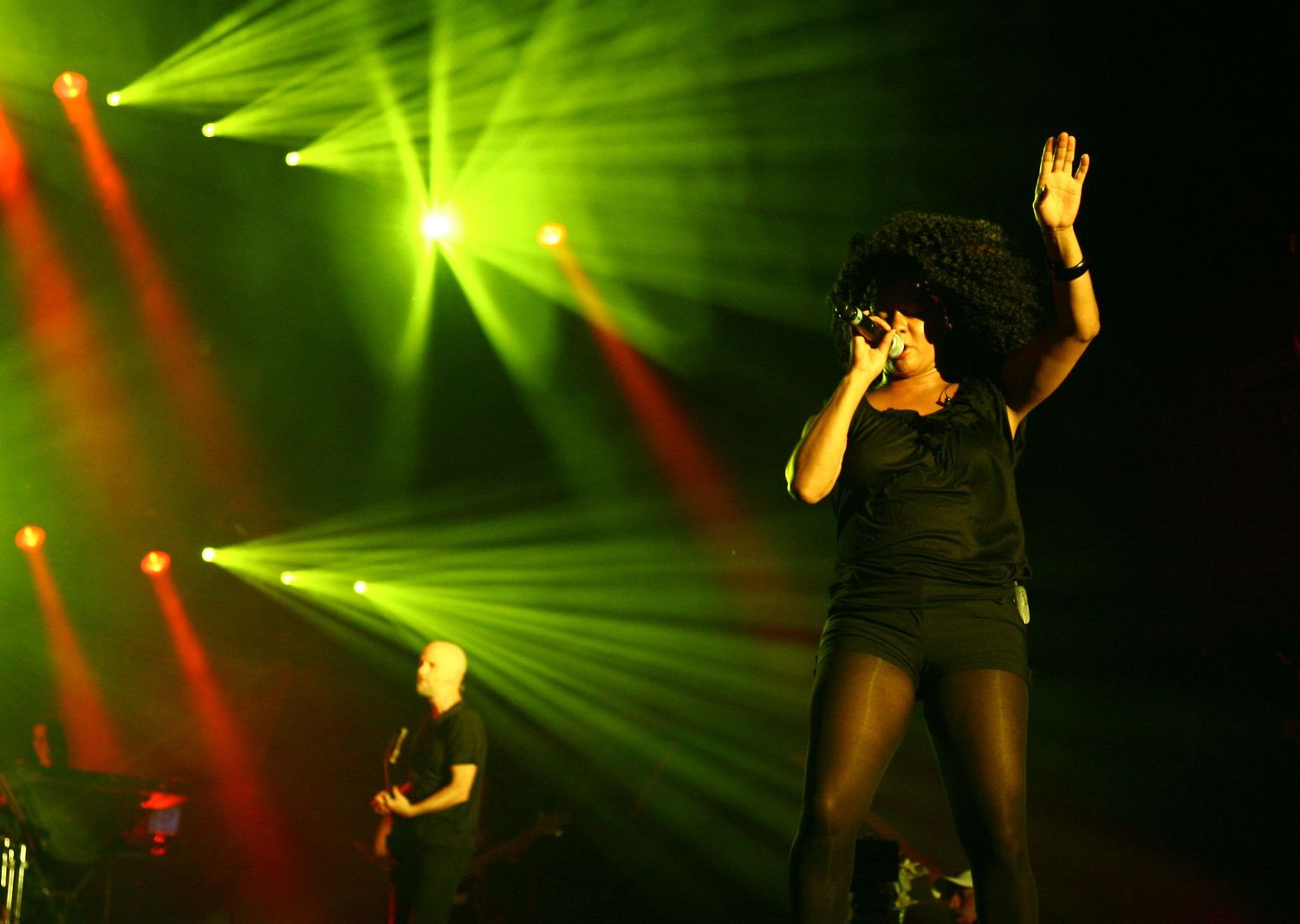 Female singer performing live on stage during a concert in NYC — powerful concert photography capturing music and emotion.