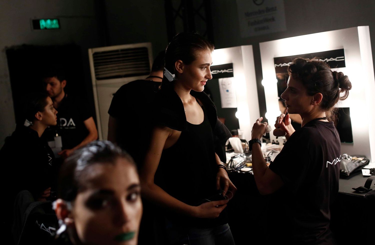 Behind-the-scenes moment from NYC Fashion Week — models and crew preparing backstage before the runway show.
