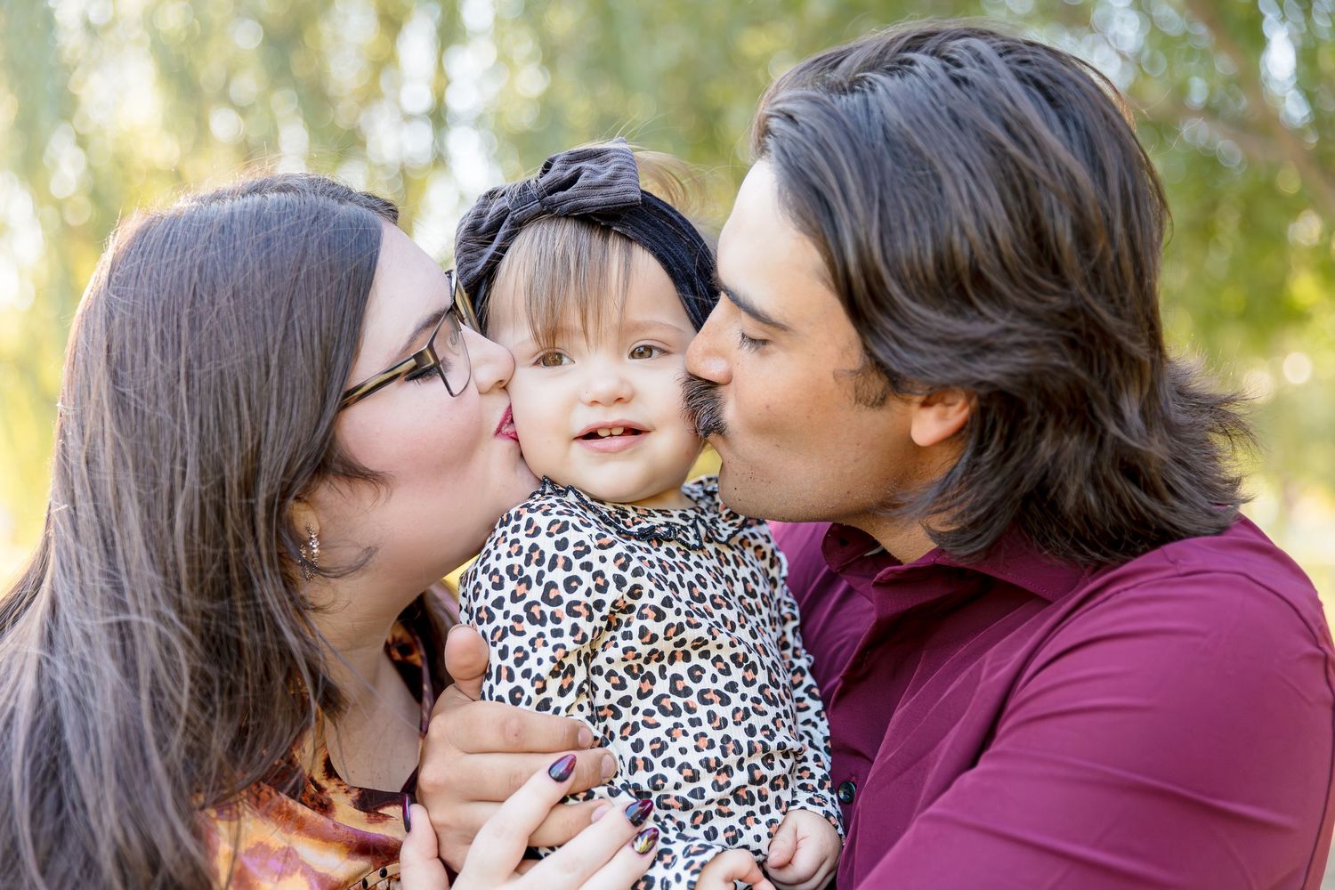 Family portrait series showing affectionate moments in a sunlit outdoor setting.