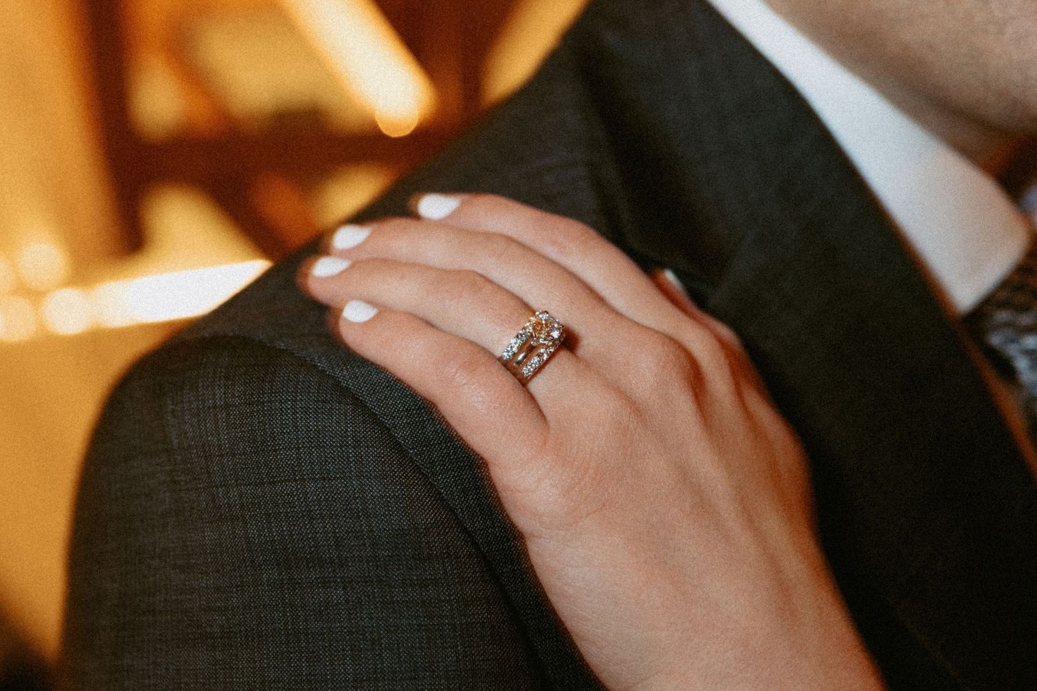 Close-up details of hands with wedding rings during an intimate moment.