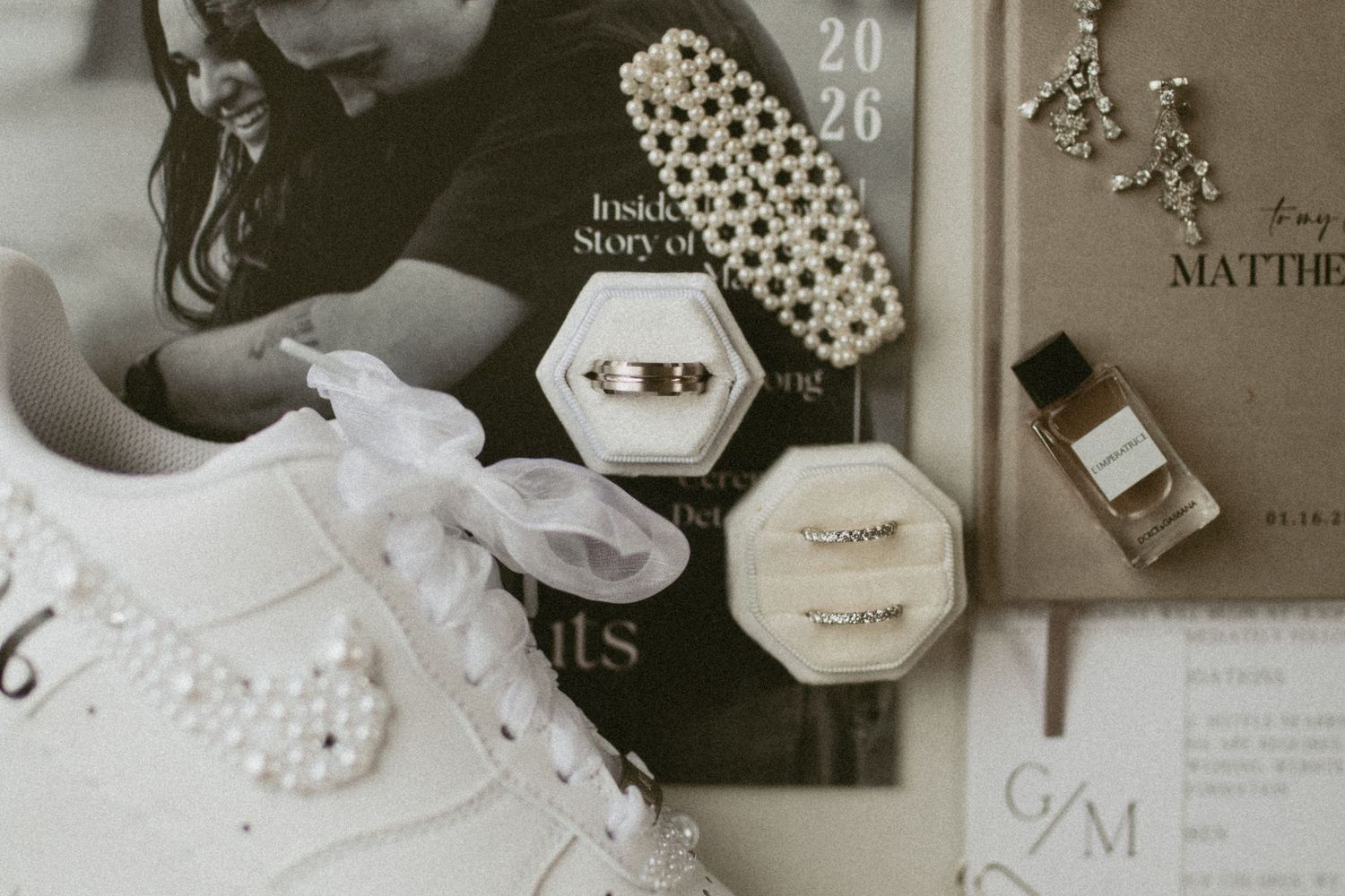 Wedding details including jewelry, invitations, and accessories arranged in vintage style.