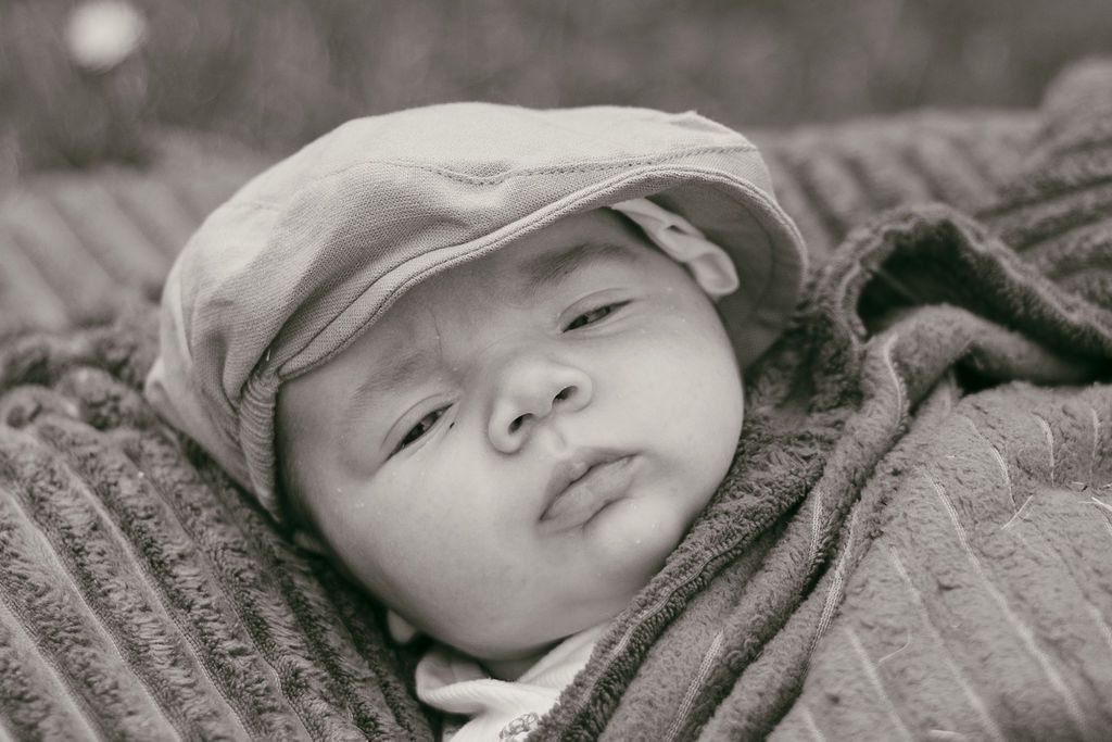 Black and white series of peaceful sleeping newborn portraits.