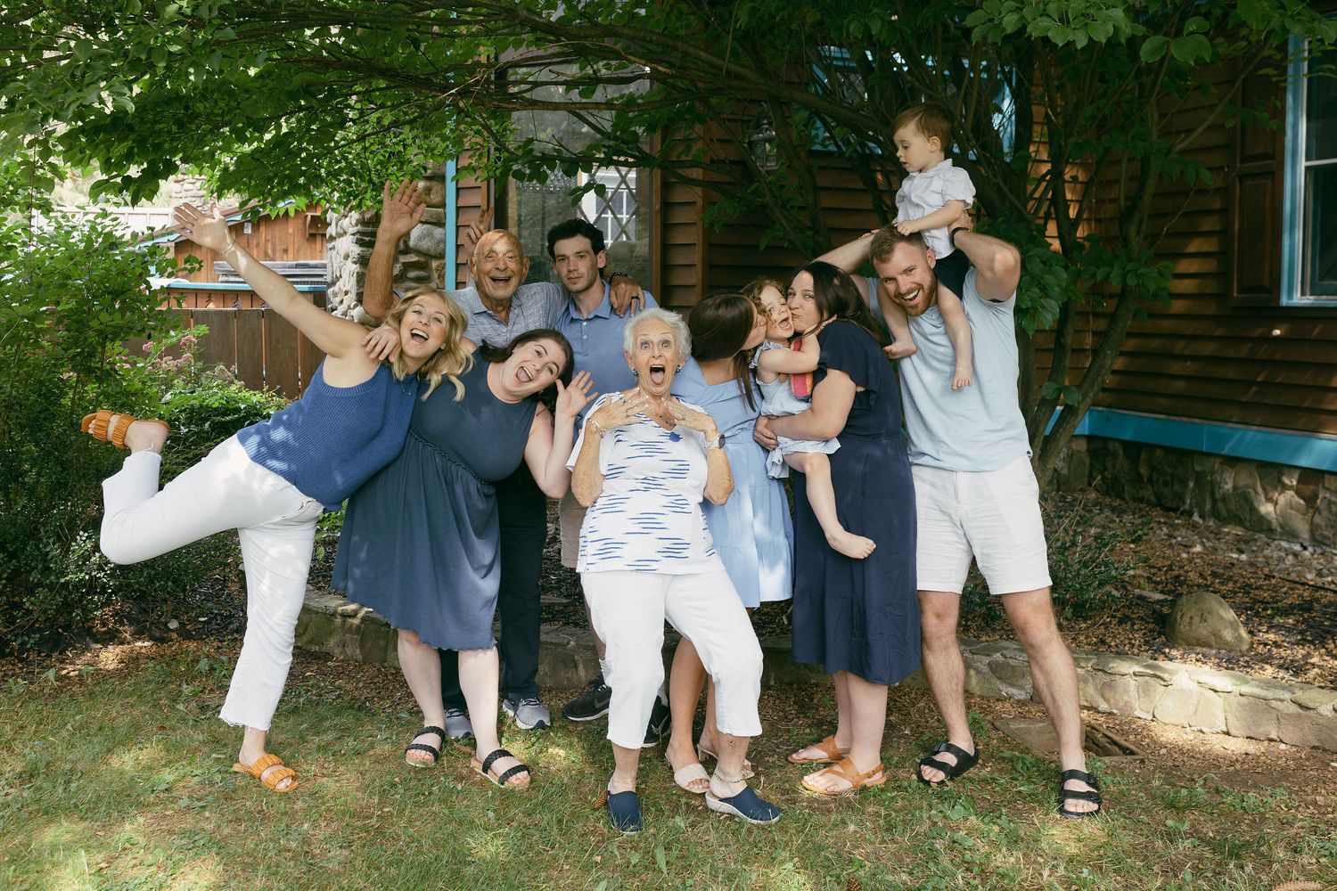 Large group in coordinated blue and white outfits posing outdoors.