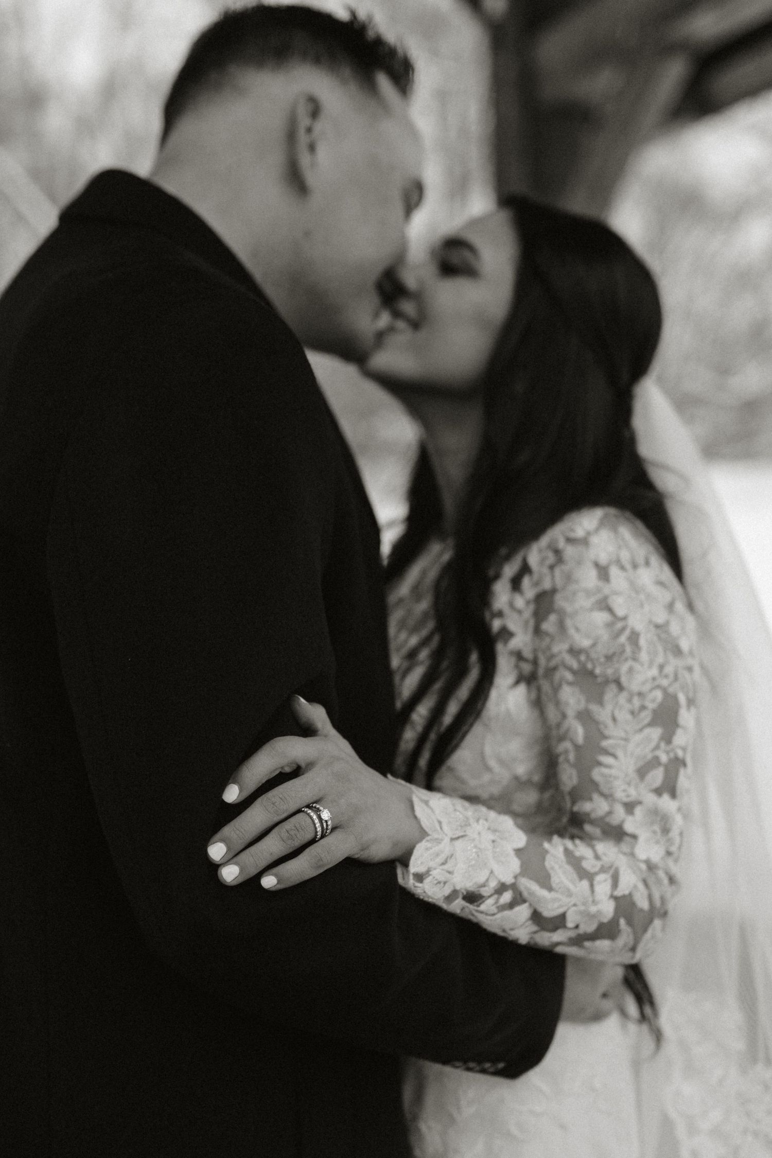 A romantic black and white wedding portrait showcasing the couple's first moments as newlyweds.