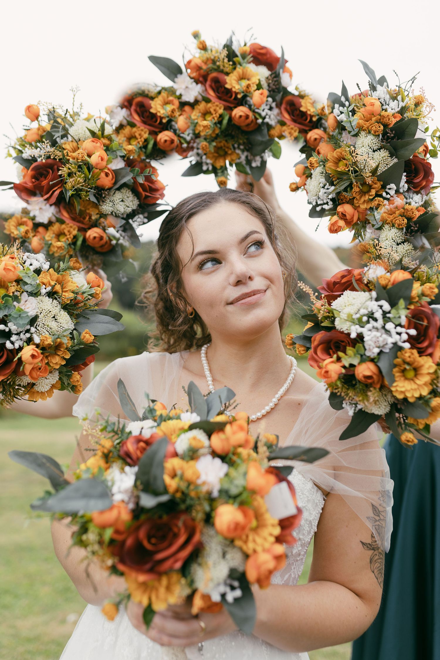 Beautiful autumn floral crown and bouquet featuring orange and white flowers with greenery.