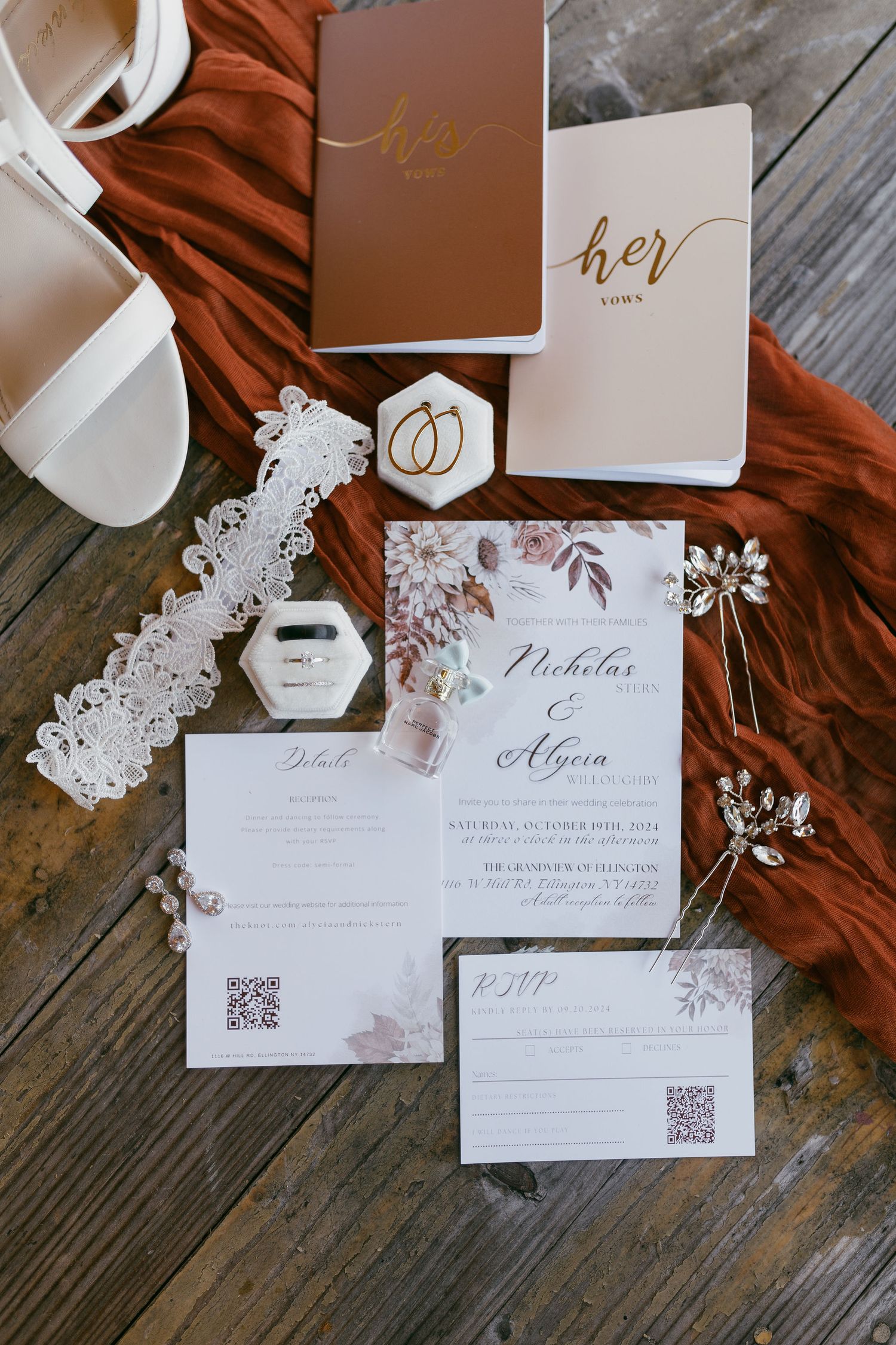Wedding invitation suite with elegant white and rose gold details on rustic wooden background.