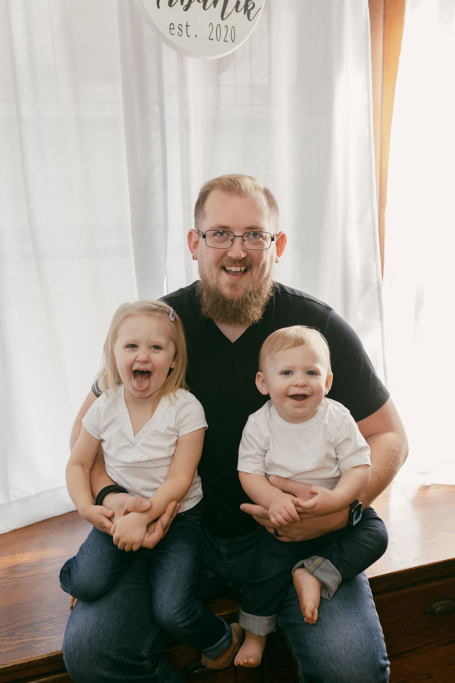 Family group sharing laughs while sitting together indoors.