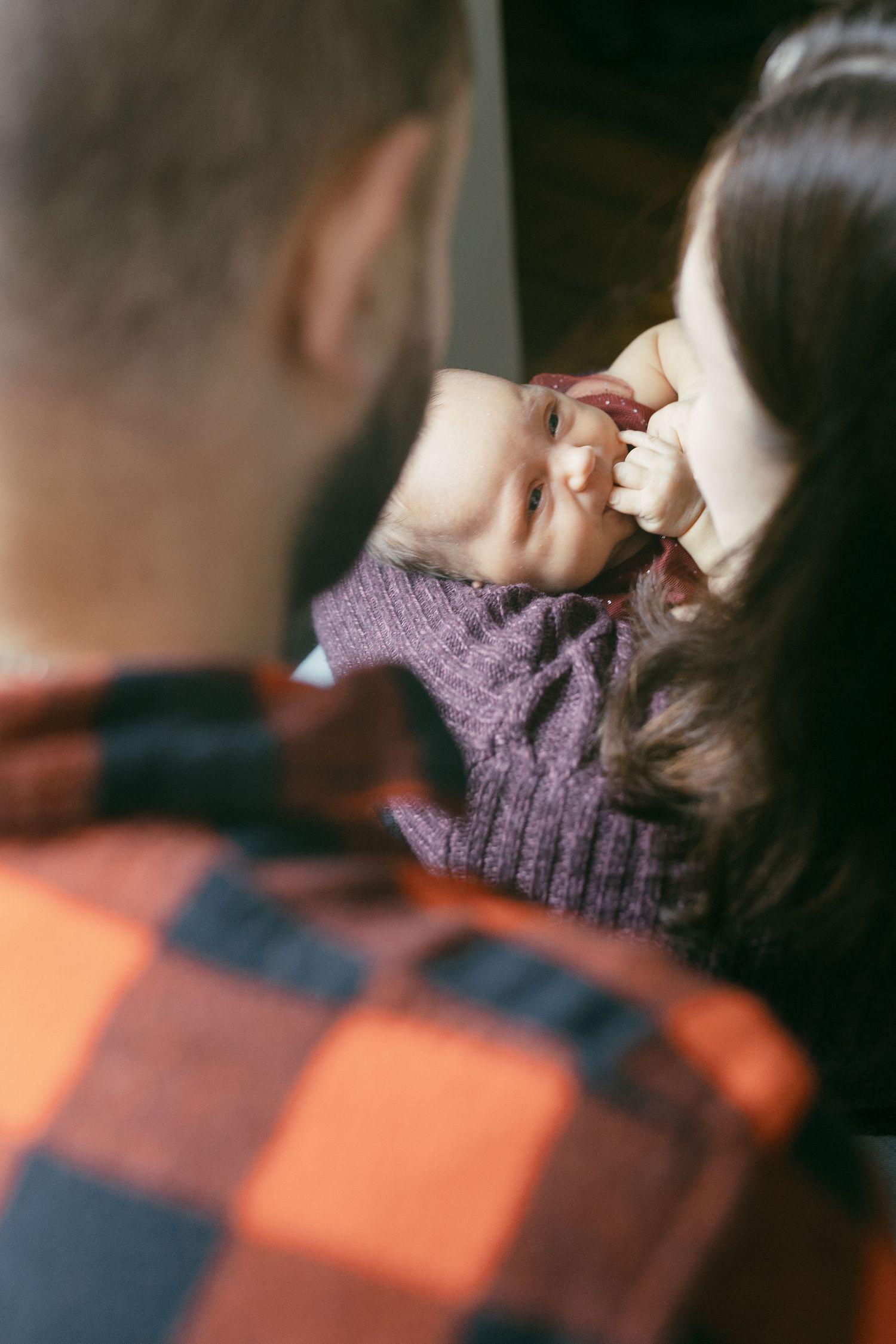 Cozy winter scene with person wearing purple knit hat in soft focus.