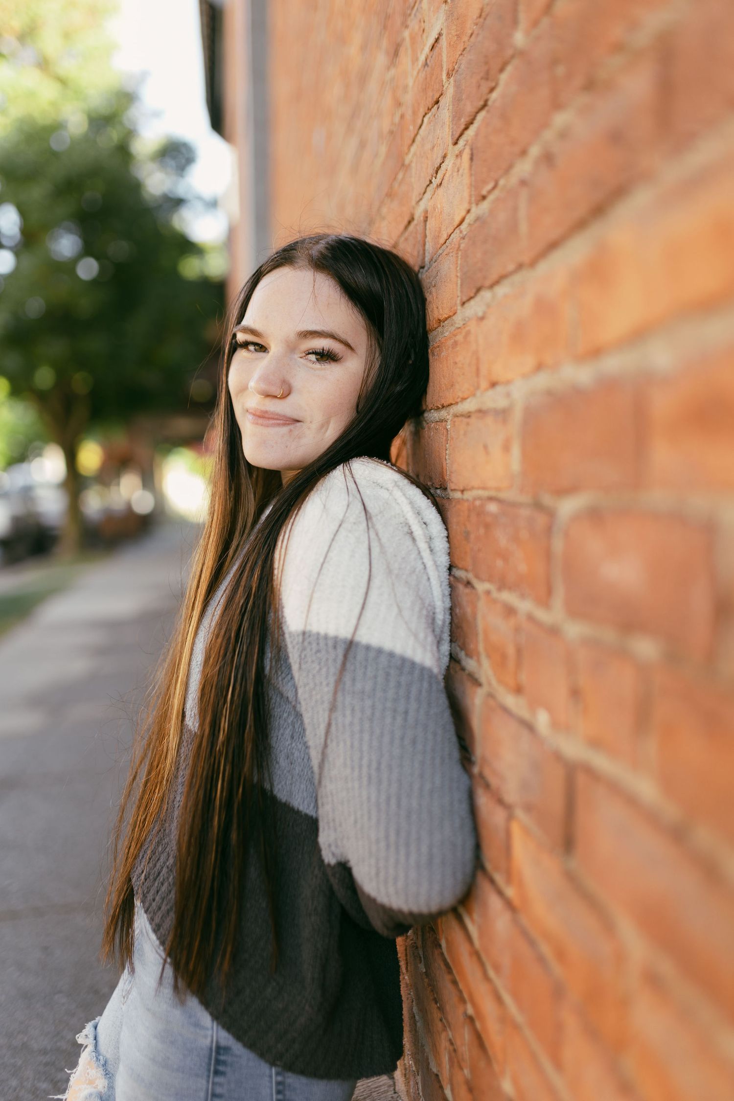 Portrait series against brick wall showing playful expressions.