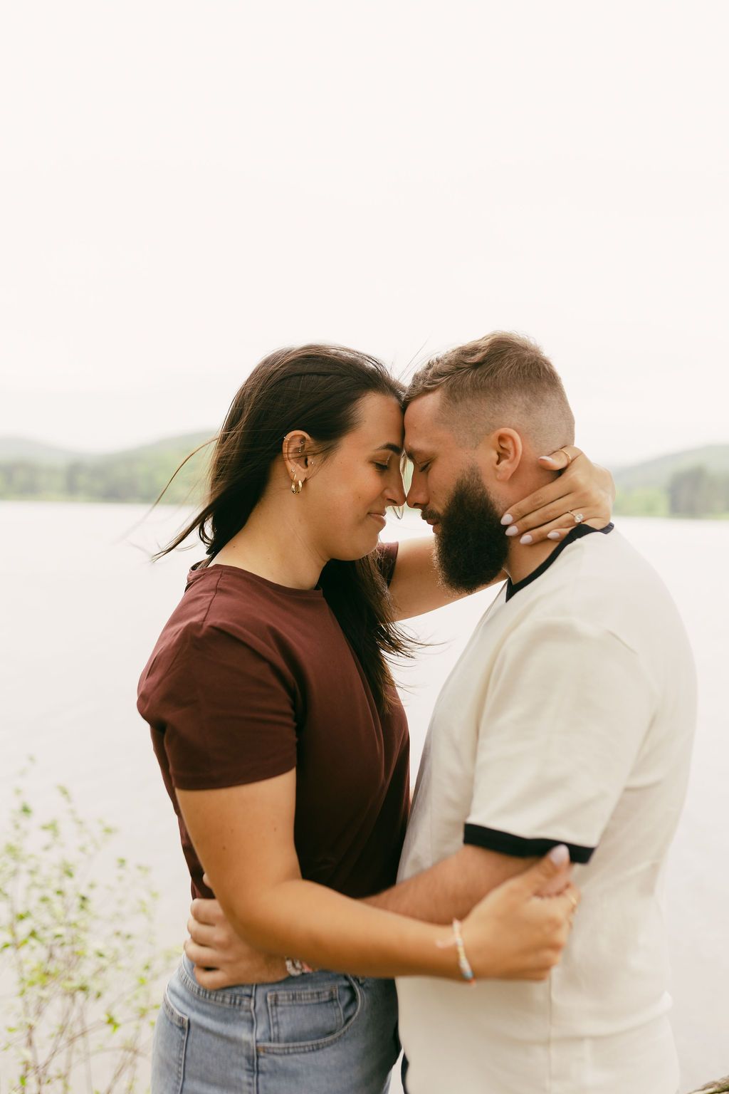 Intimate couple photos with lake and nature backdrop.