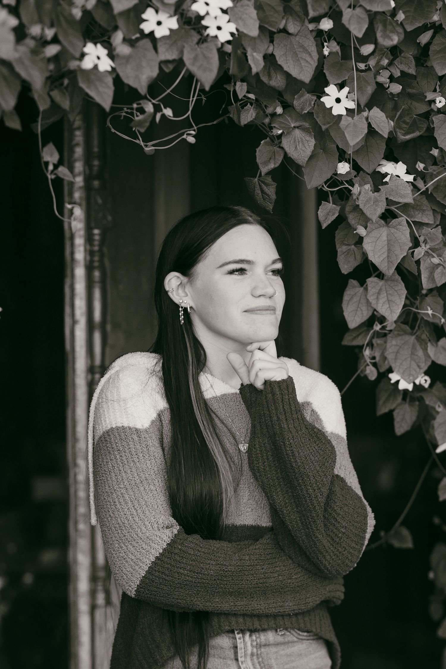 Black and white portraits showing artistic poses with leaves and vines in the background.