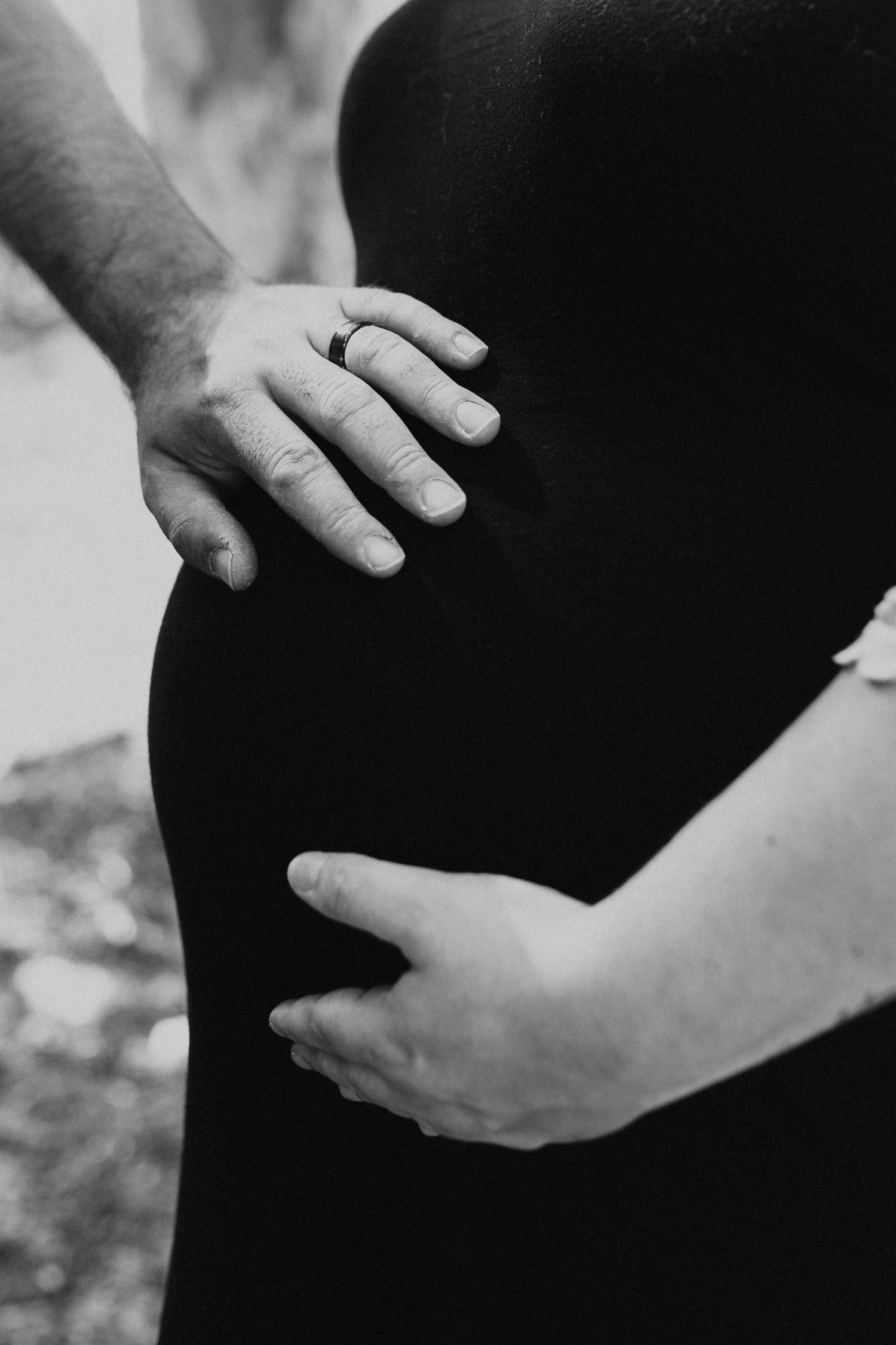 Black and white close-up shots of gentle hands cradling with care and tenderness.