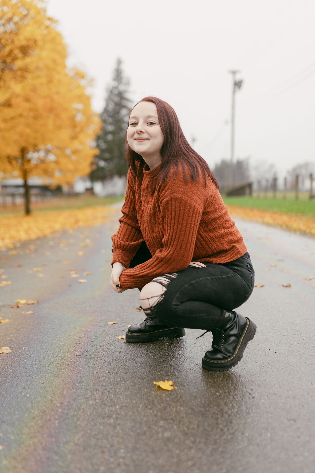Creative poses on wet pavement with fall foliage in the background.