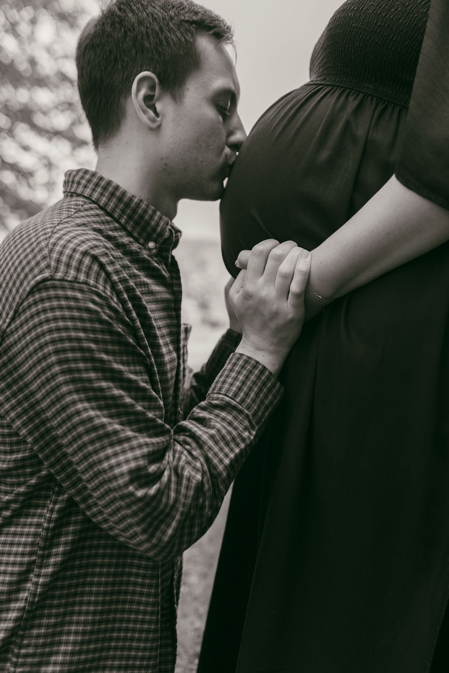 Black and white series showing intimate moments between expectant parents.