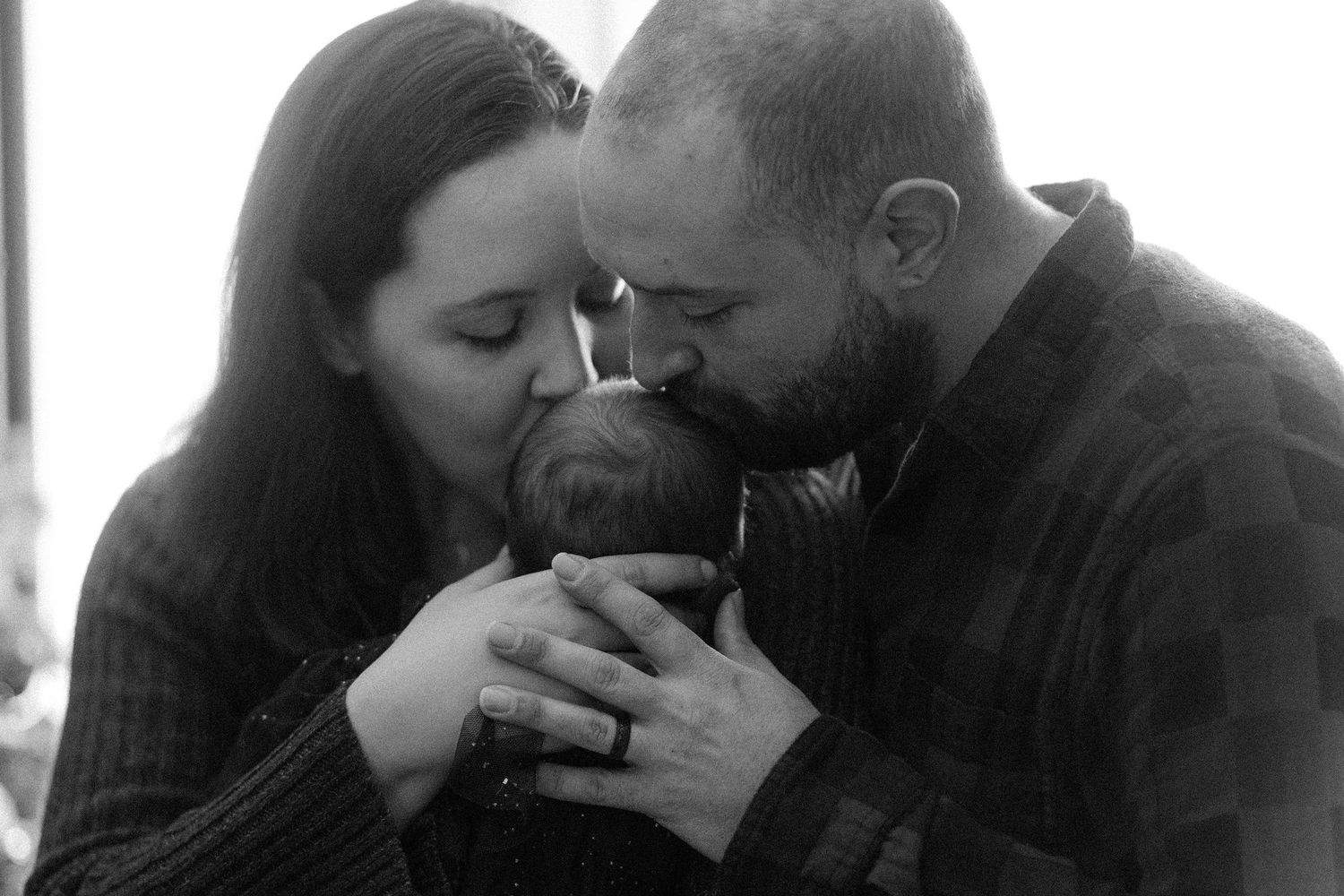Intimate couple sharing tender moments in black and white photography.
