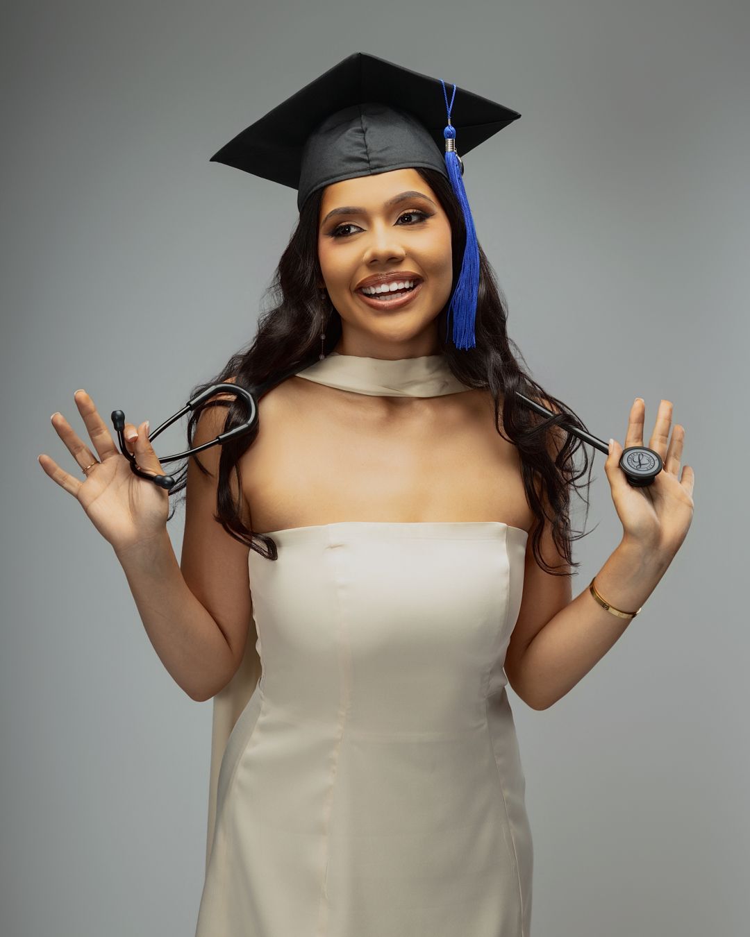Graduation photo session in-studio with creative posing and clean white backdrop by Rashad Gilmore