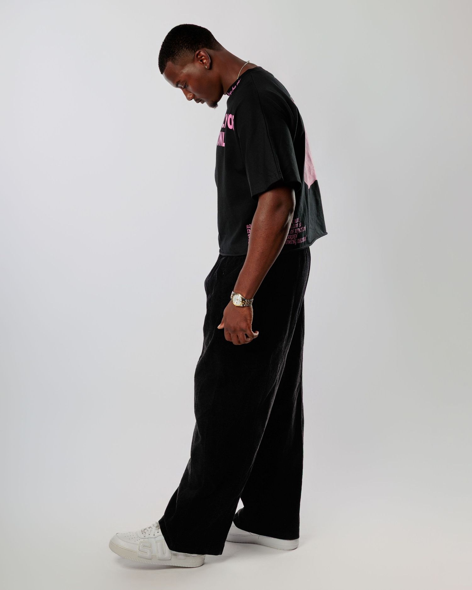 A sequence of photos showing a person in black clothing bending down to examine something on a light gray background.