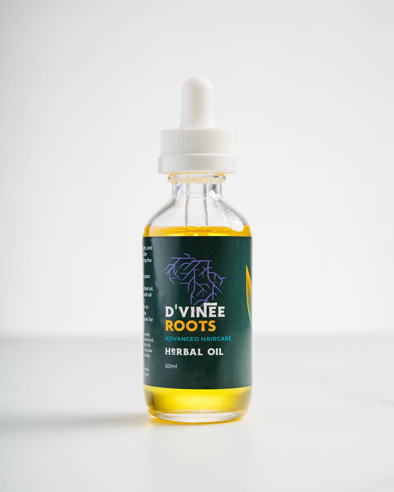 A bottle of D'Vinee Roots herbal oil with a dropper cap against a white background.