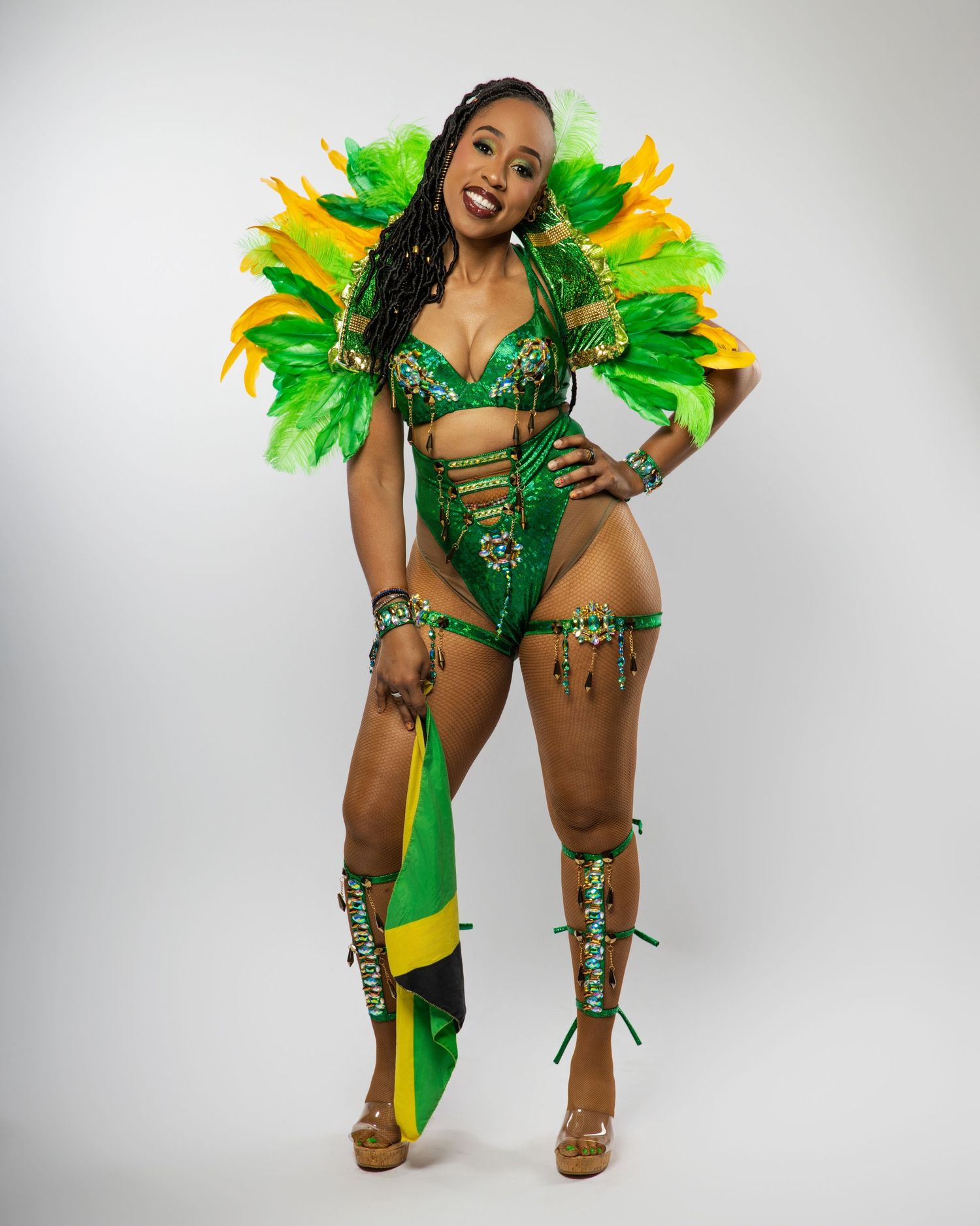 Festive carnival costume featuring green and yellow feathers with matching accessories.