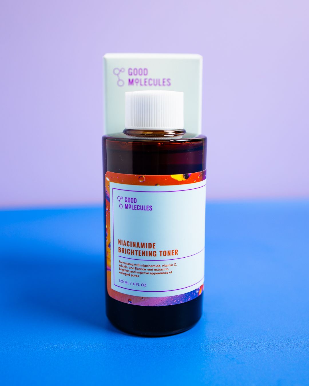 A series of amber glass jars with white labels showing Good Molecules skincare products against purple and blue backgrounds.