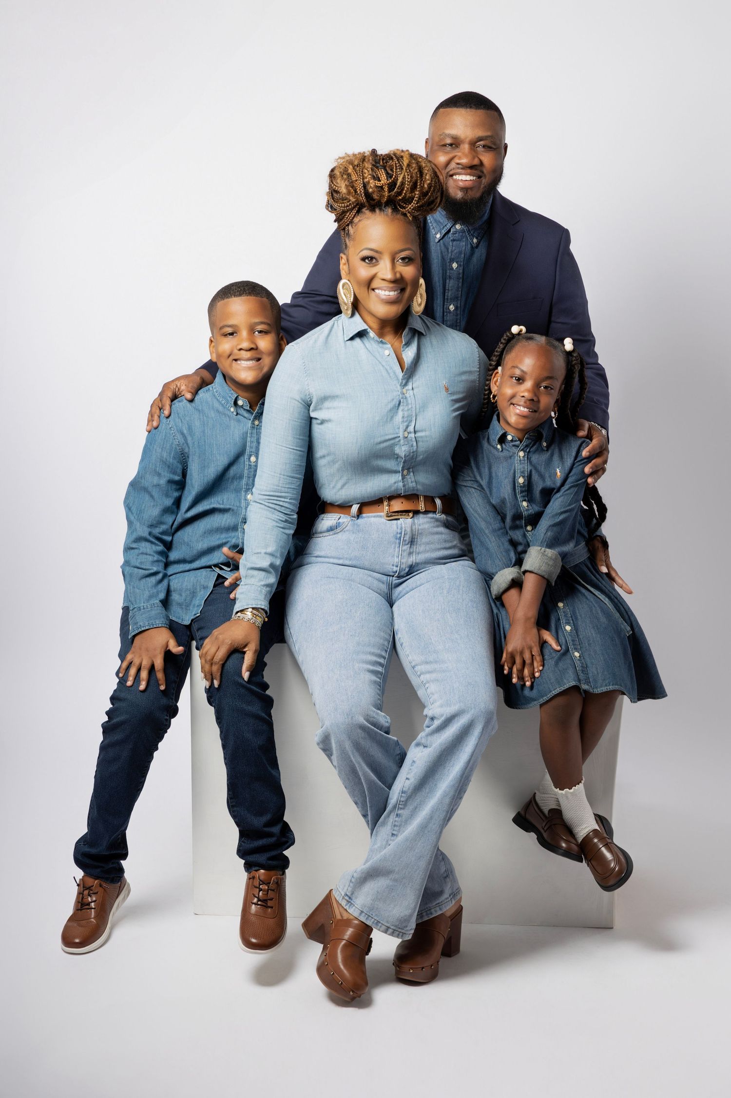 A series of casual family portrait poses showing a parent and children sitting together against a light background.