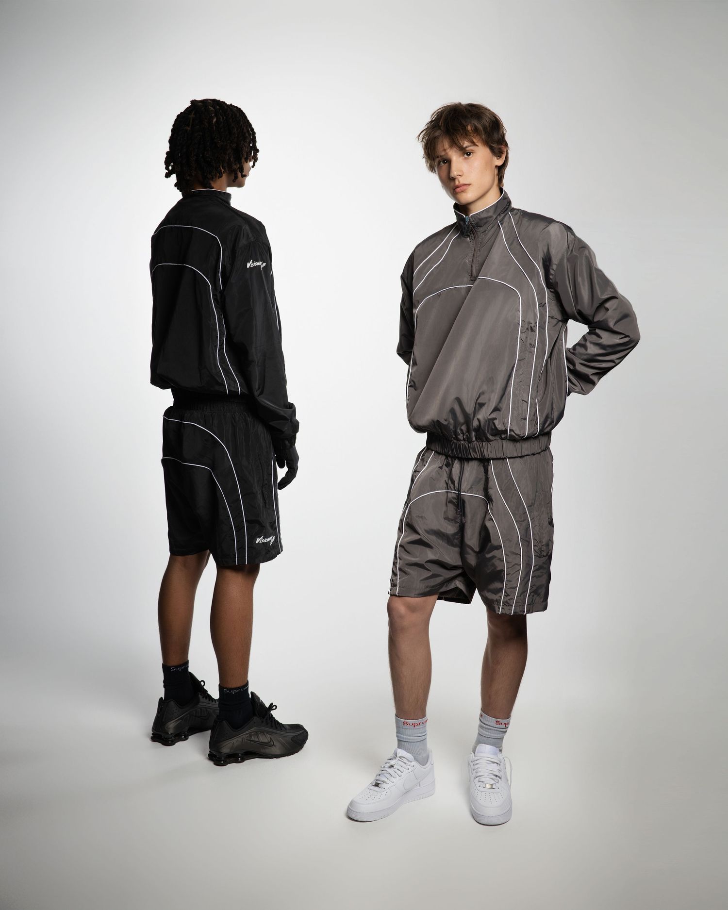 A collection of fashion photos showing black and gray athletic wear with reflective piping details against a white background.