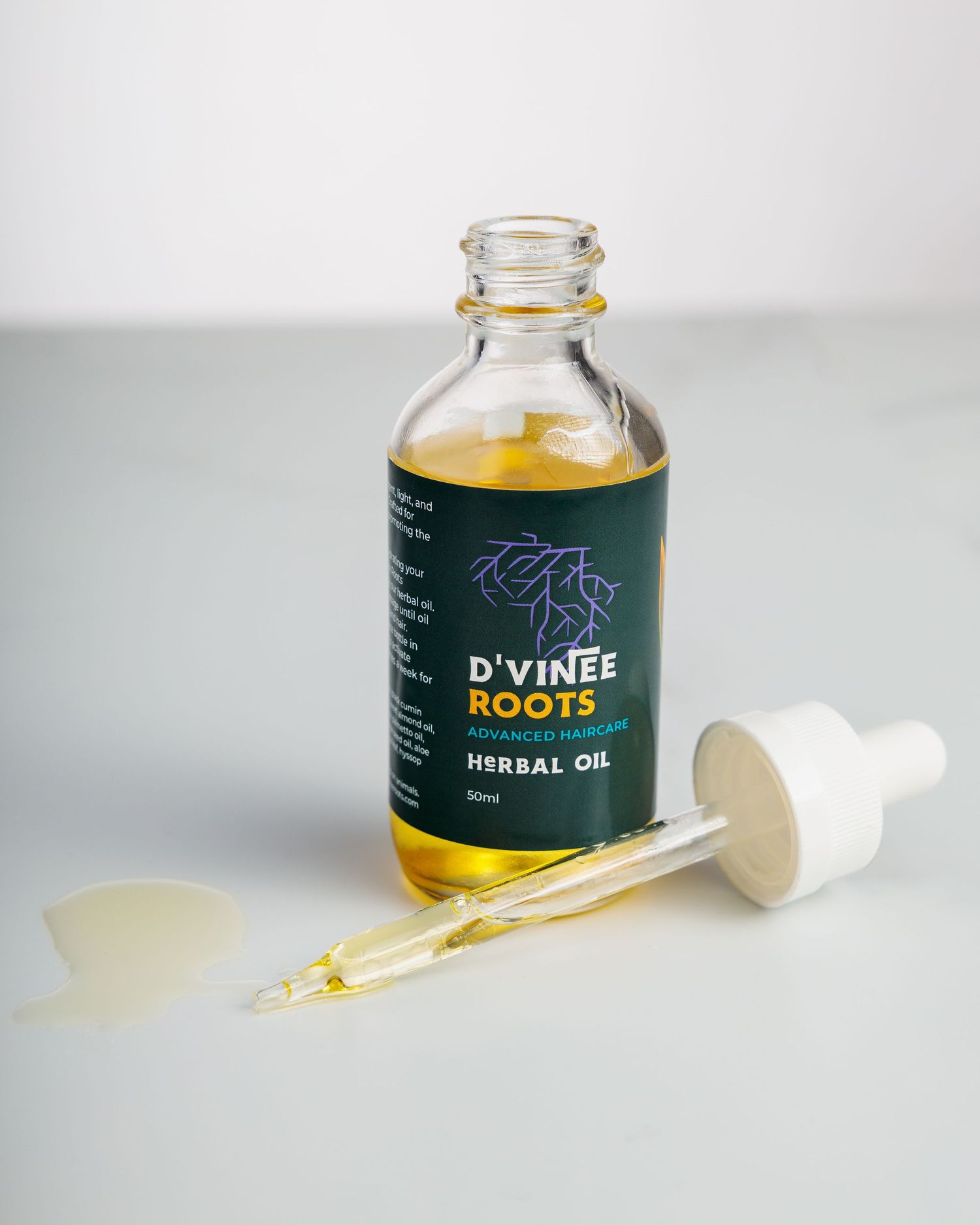 Small glass bottle of herbal oil with dropper showing golden liquid against white background in multiple views.