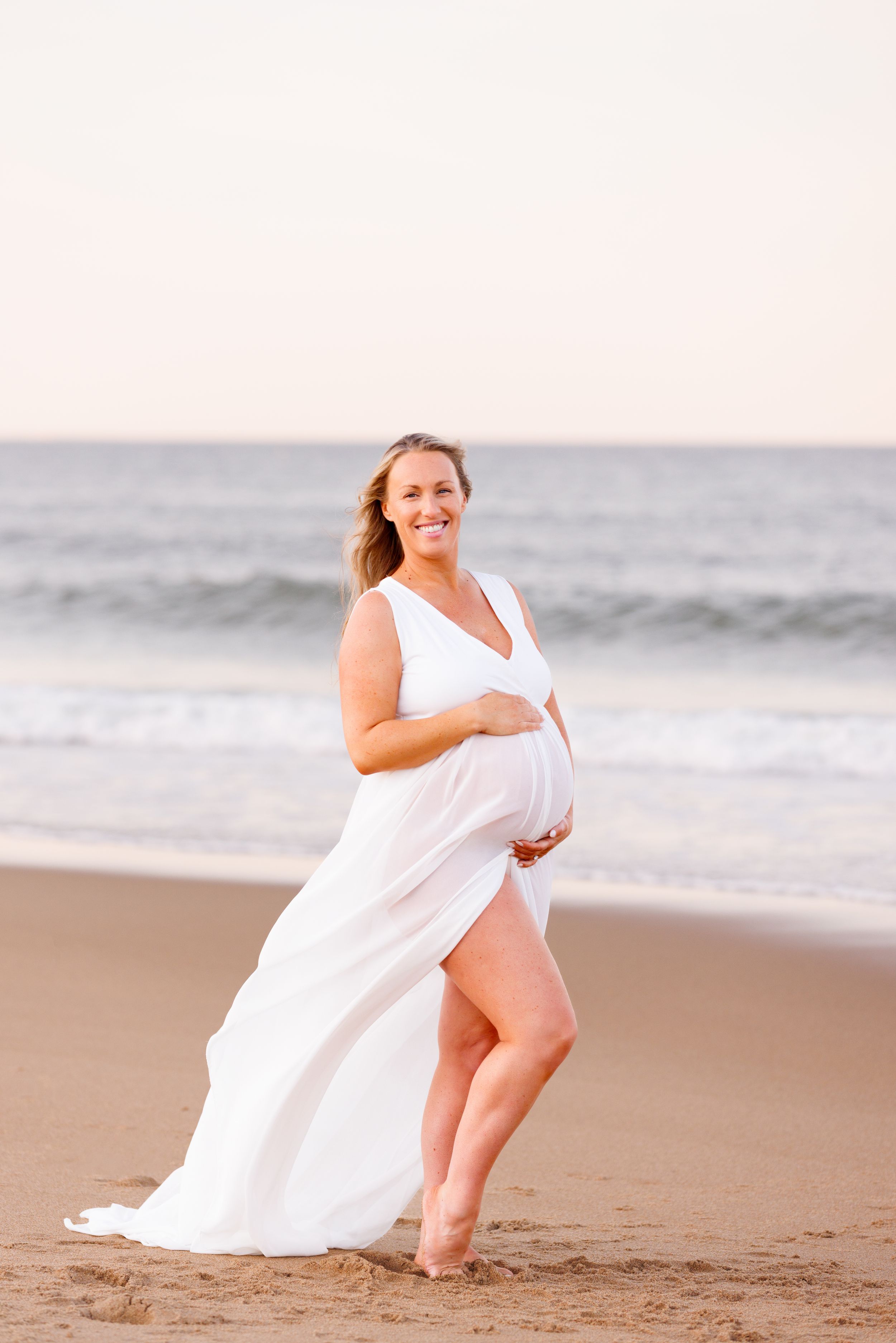 Outdoor maternity portrait photographed at the beach during a New Hampshire maternity session