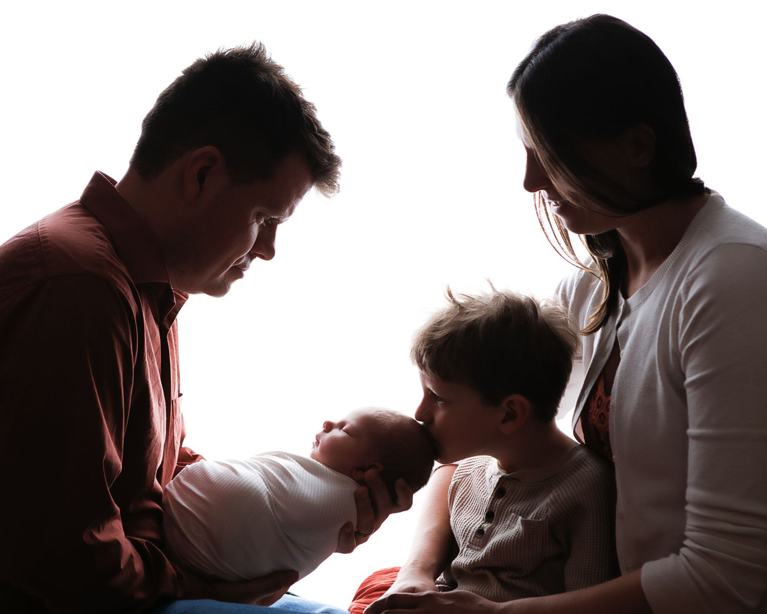 Family with newborn baby and older sibling photographed during a Salem NH newborn photography session